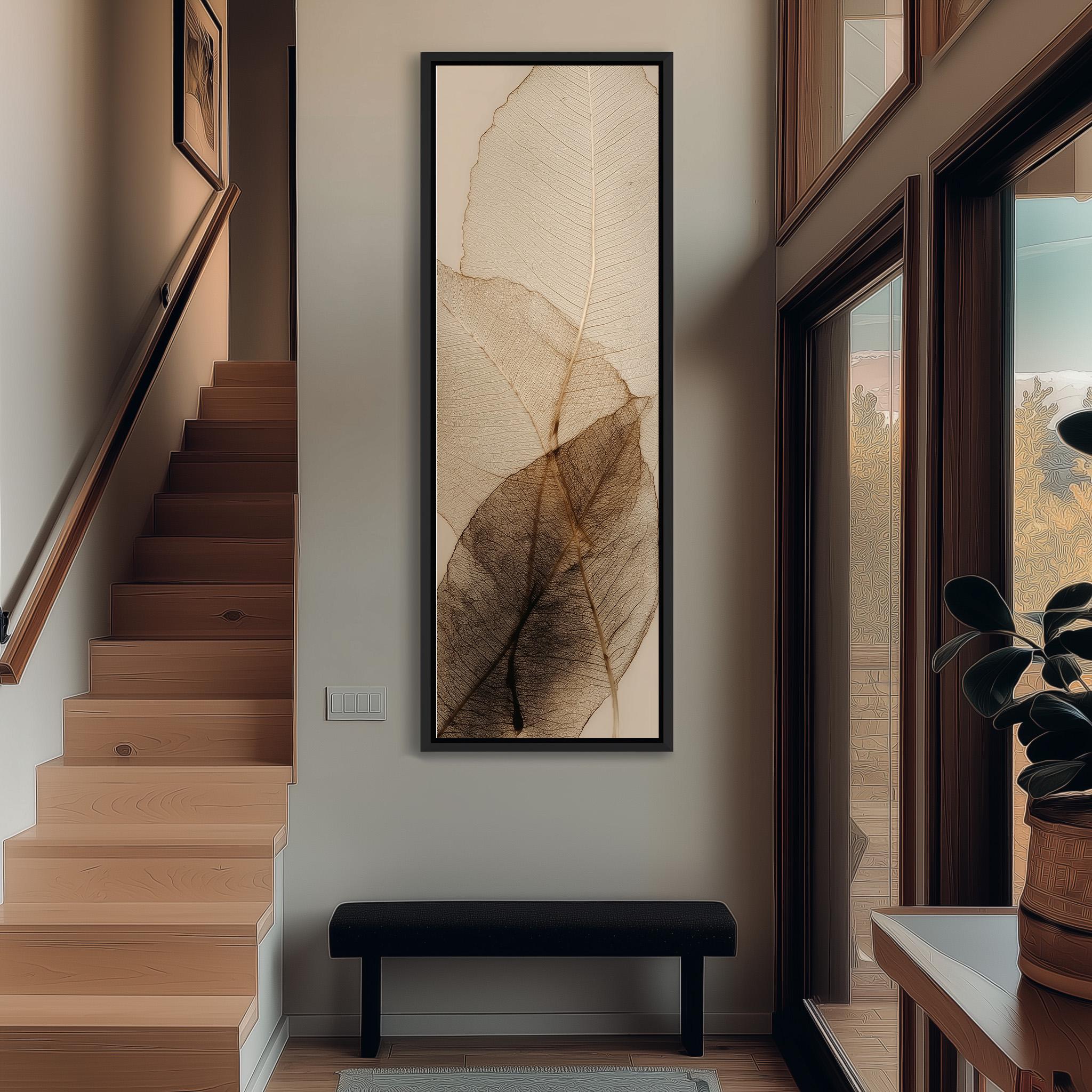 a modern and minimalist interior design, featuring a large framed artwork of leafy textures hanging on the wall, a wooden staircase, a black bench, and a potted plant.