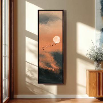 Birds flying past a rising moon in an orange sky long vertical canvas print in a sunlit living space