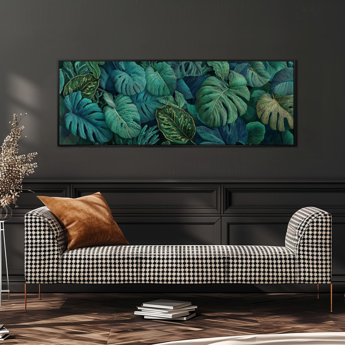 a large, framed painting of tropical leaves hanging on a wall above a brown sofa.