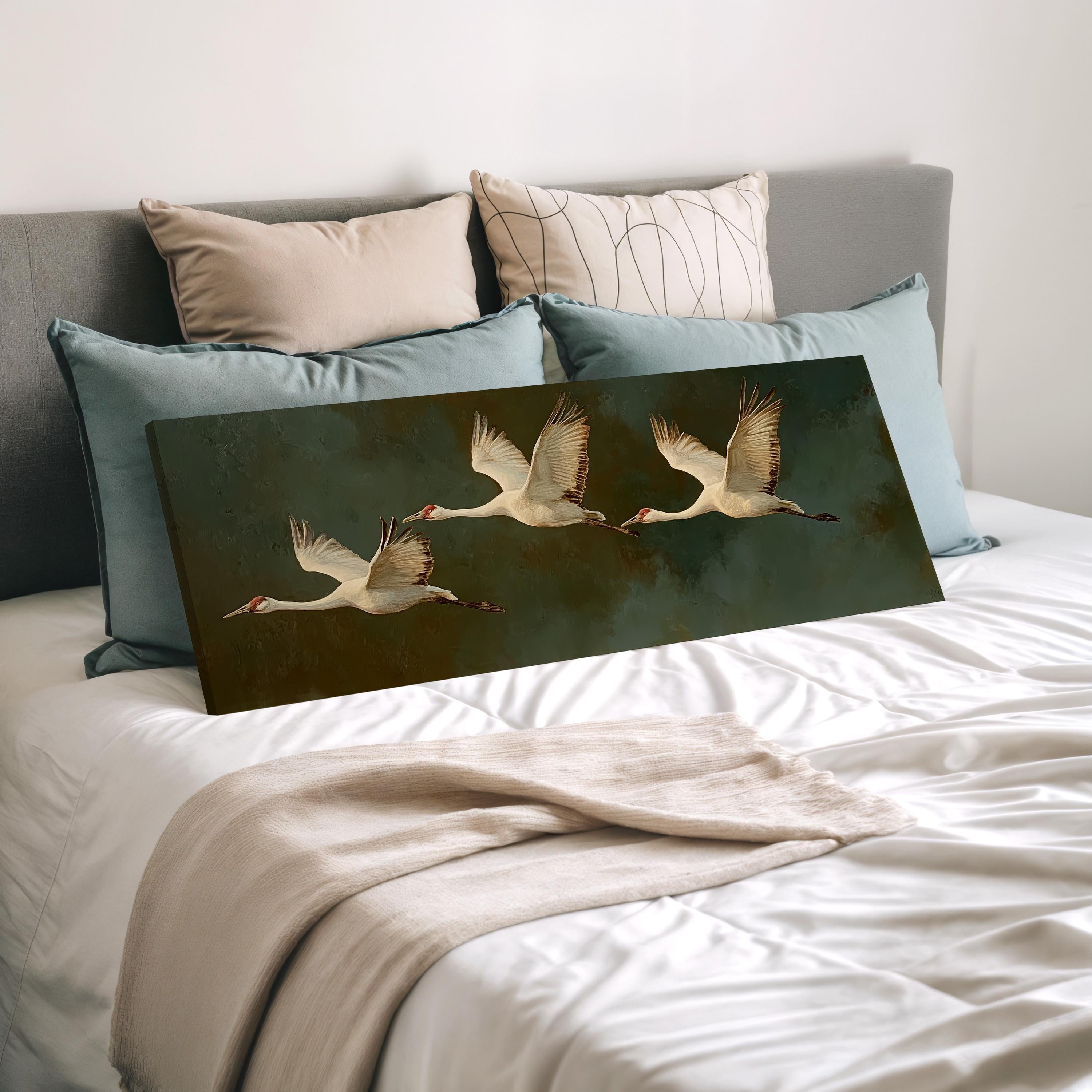 a bedroom with a bed and a painting of three swans in flight.