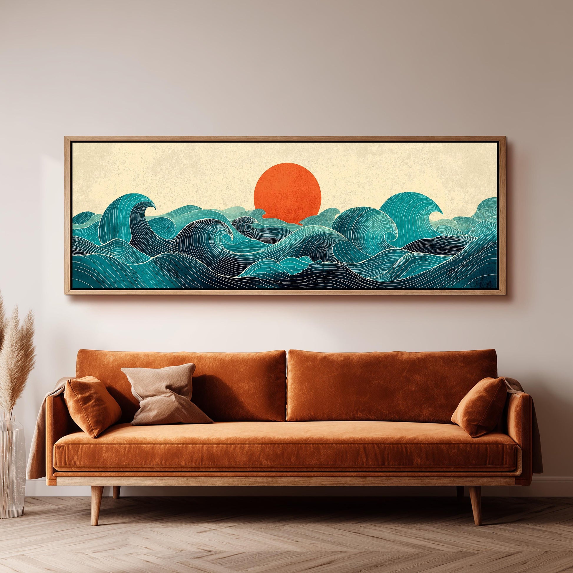 a large, framed artwork depicting a seascape with a sun in the background, hanging on a wall above a brown sofa.