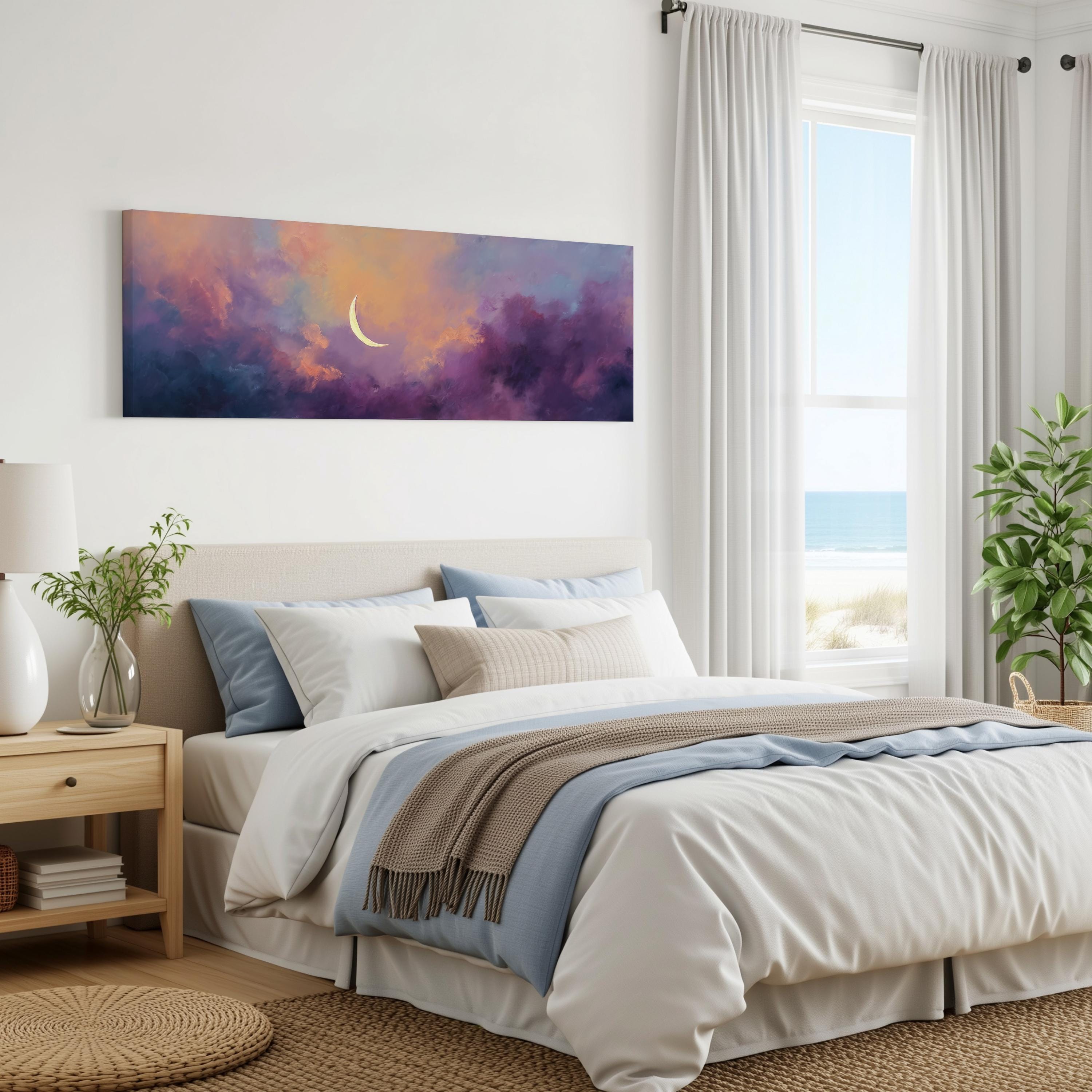 a serene bedroom with a large bed, a nightstand, and a painting of a crescent moon and a colorful sky above it. The room has white walls and a window overlooking the ocean, creating a peaceful and relaxing atmosphere.