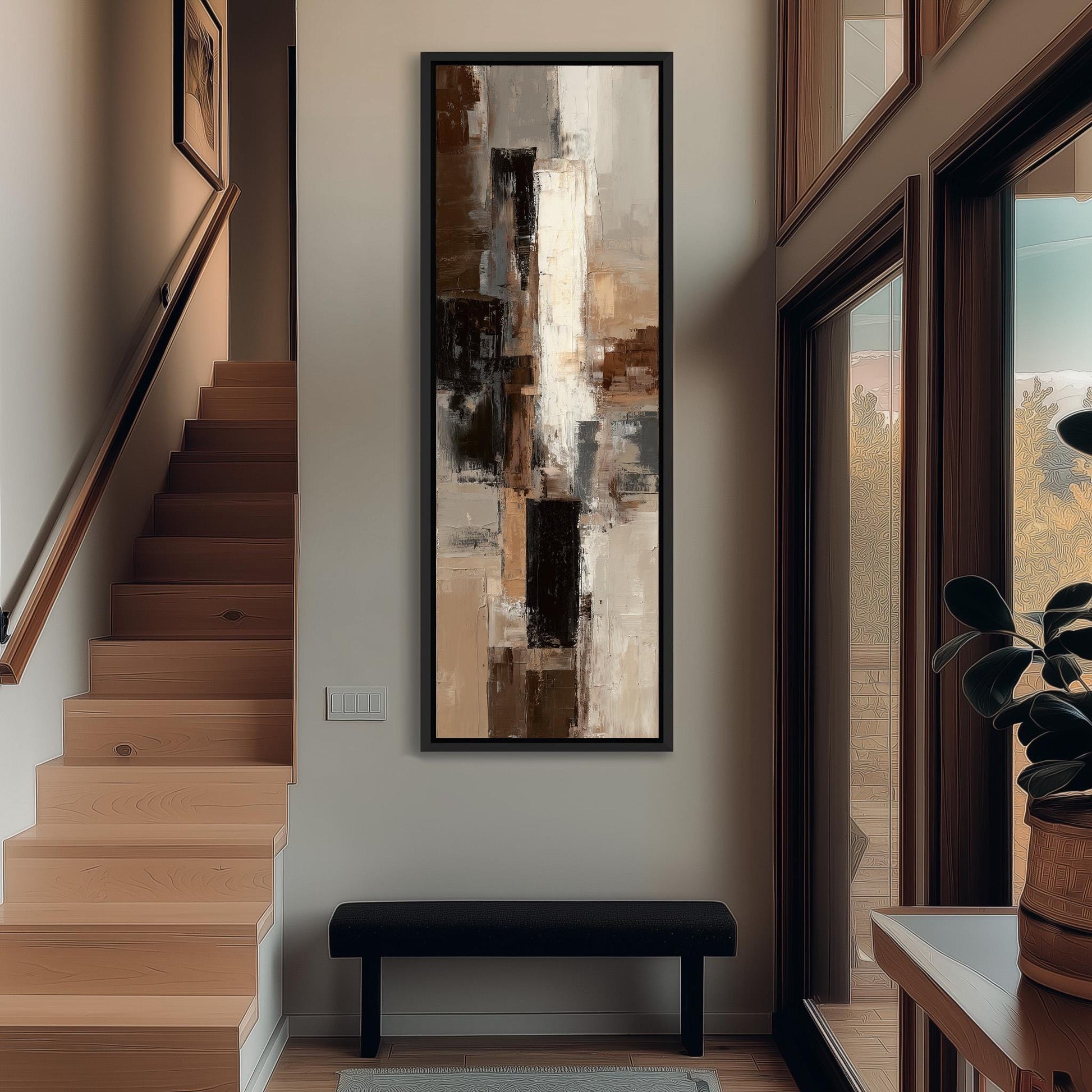 a modern interior design with a large abstract painting hanging on the wall above a black bench. The painting has a mix of brown, white, and gray colors, creating a visually striking contrast. The room also includes a wooden staircase, a potted plant, and a window that allows natural light to enter the space.