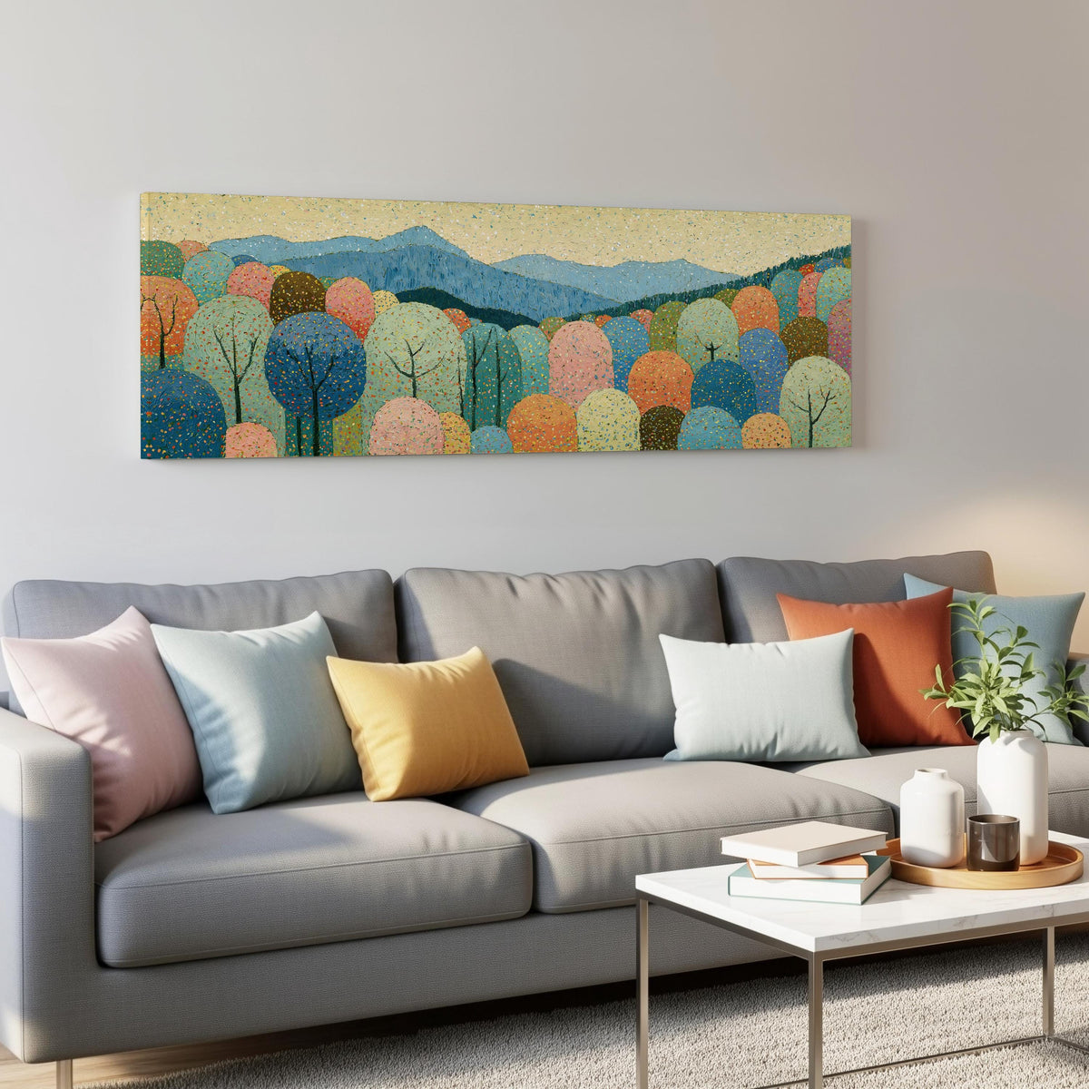 Pastel dotted forest below blue mountains panoramic canvas print above a grey sofa in a living room