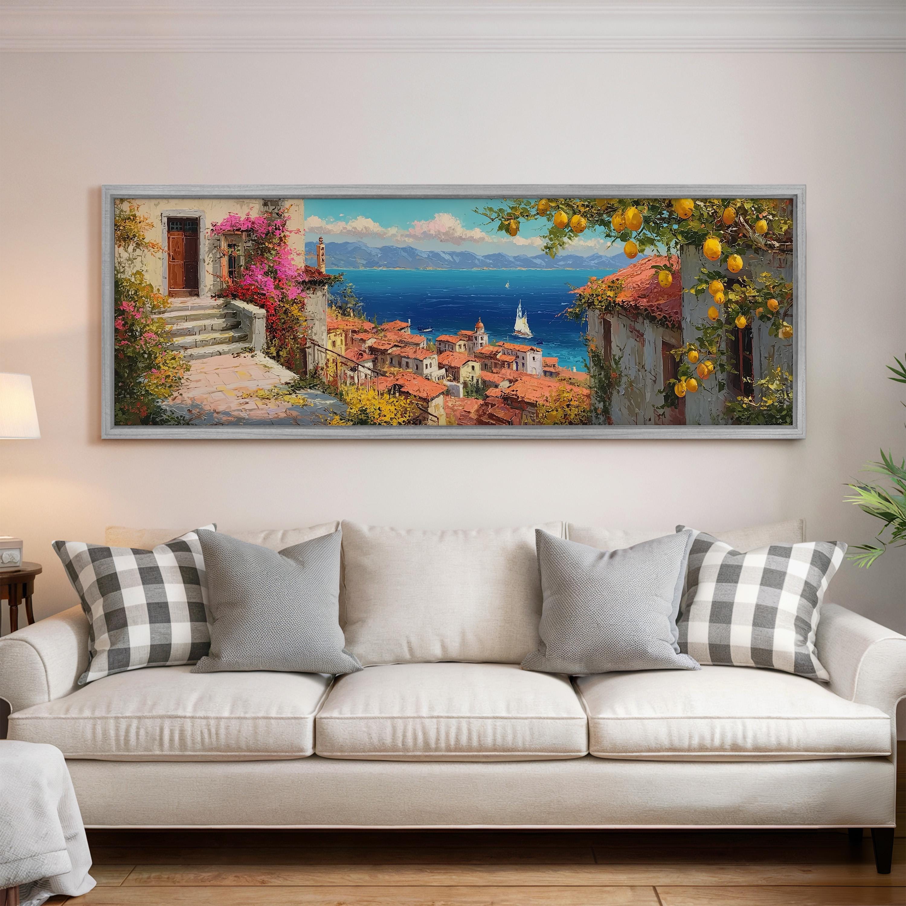 a large, framed painting of a picturesque coastal town with a view of the sea and mountains in the background.