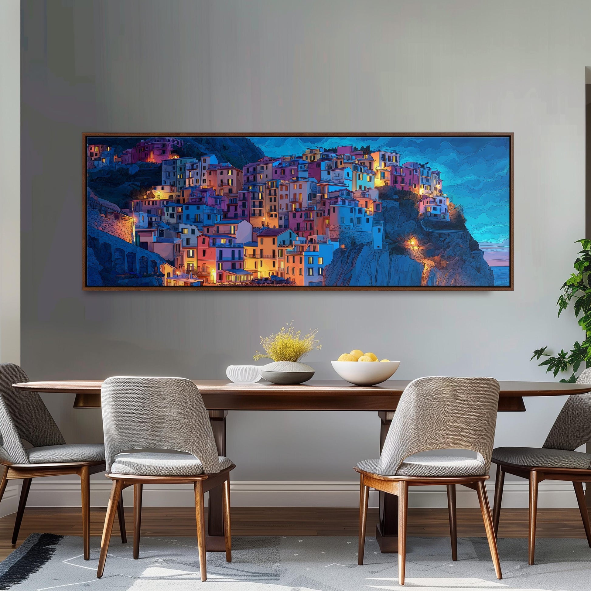 a large, colorful painting of a town or village on the wall above a wooden dining table with four chairs.