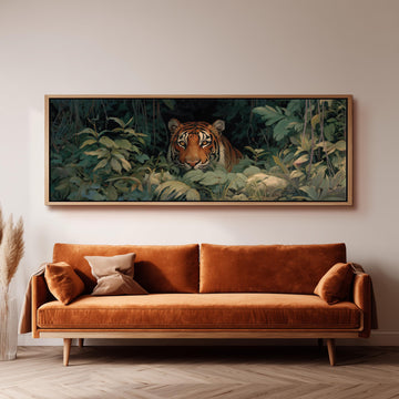 a large painting of a tiger in a lush, green jungle setting, hanging on a wall above a brown sofa.