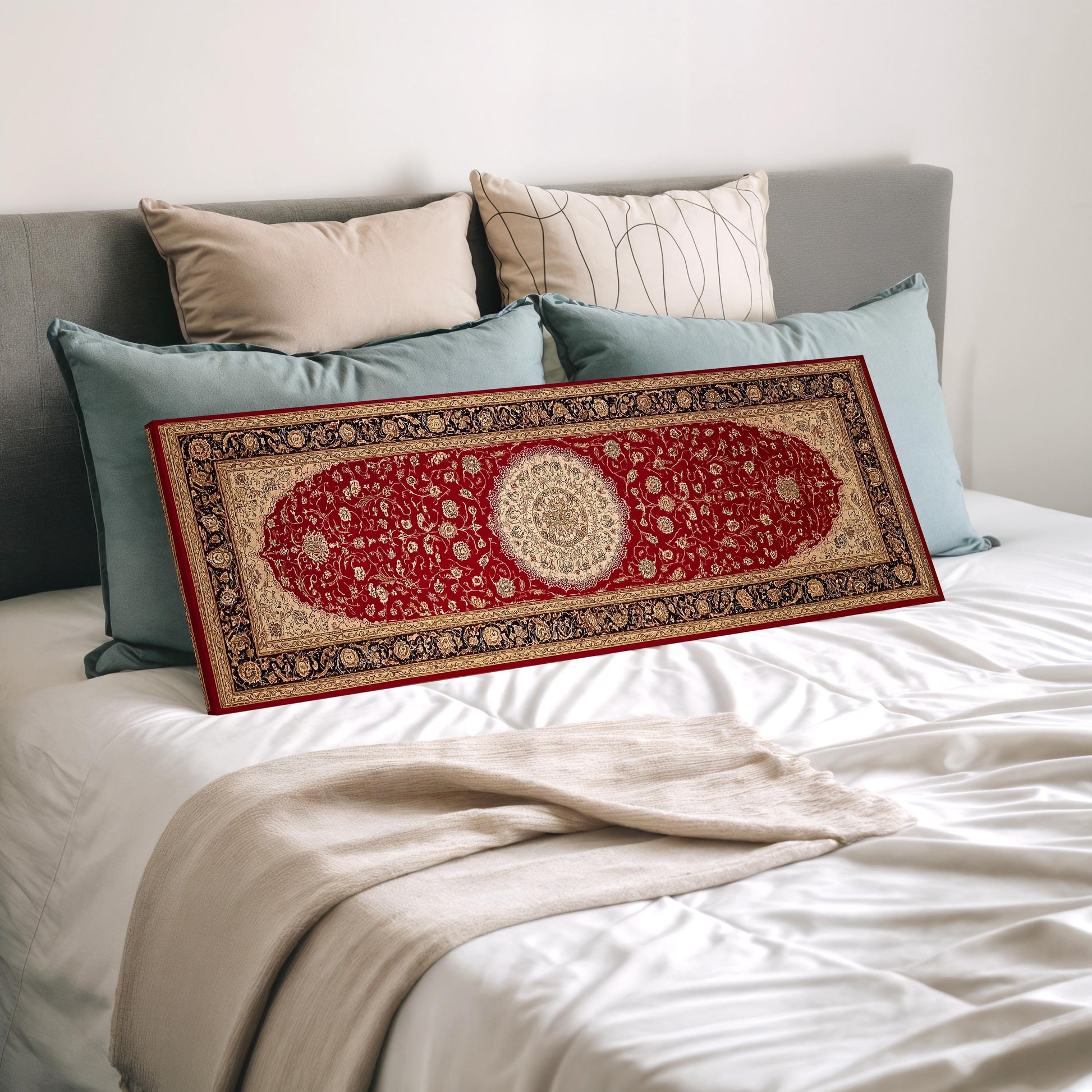 a large, ornate red and gold rug placed on a bed with a white comforter and several pillows.