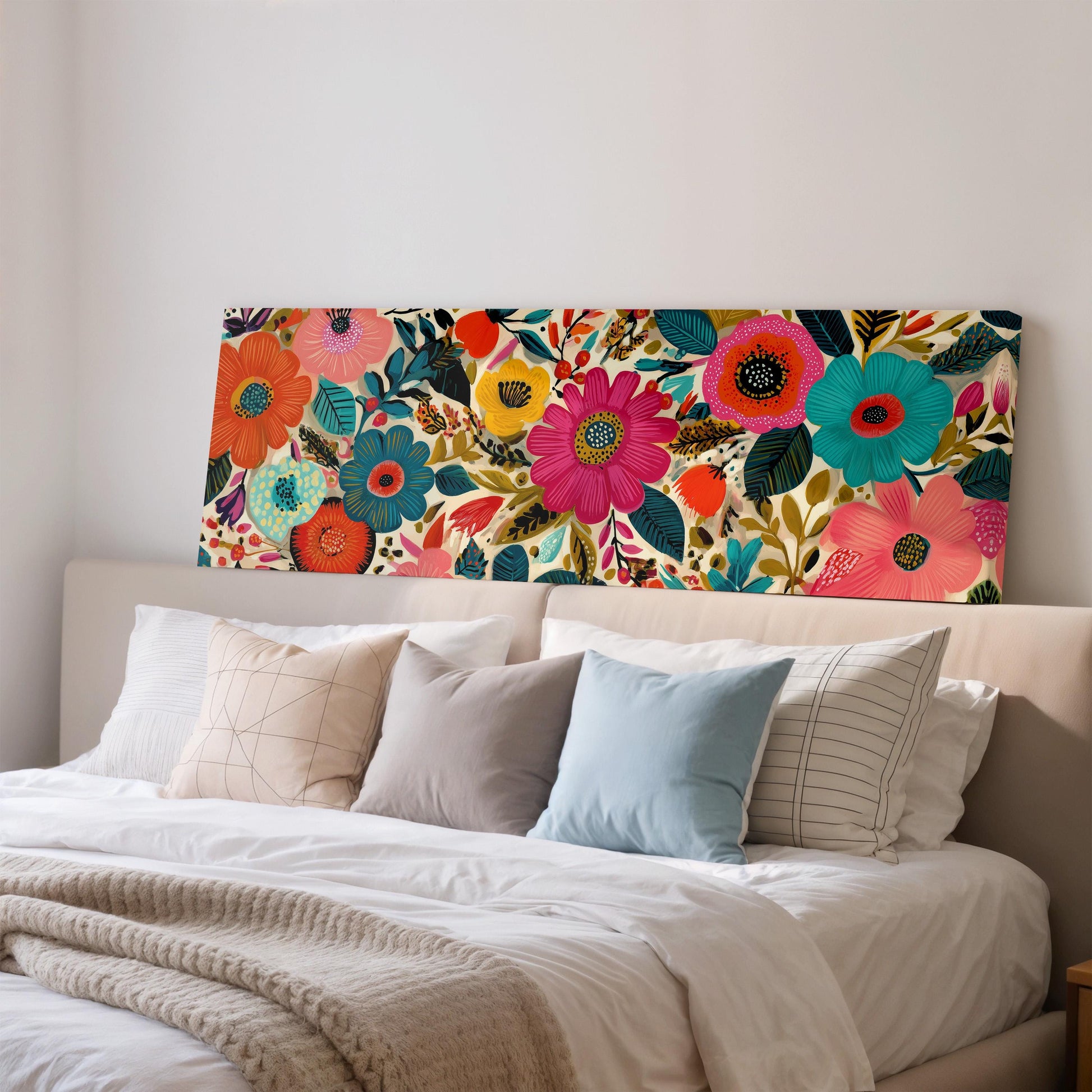 a bedroom with a large floral print on the wall behind a bed, which is adorned with a variety of colorful pillows.