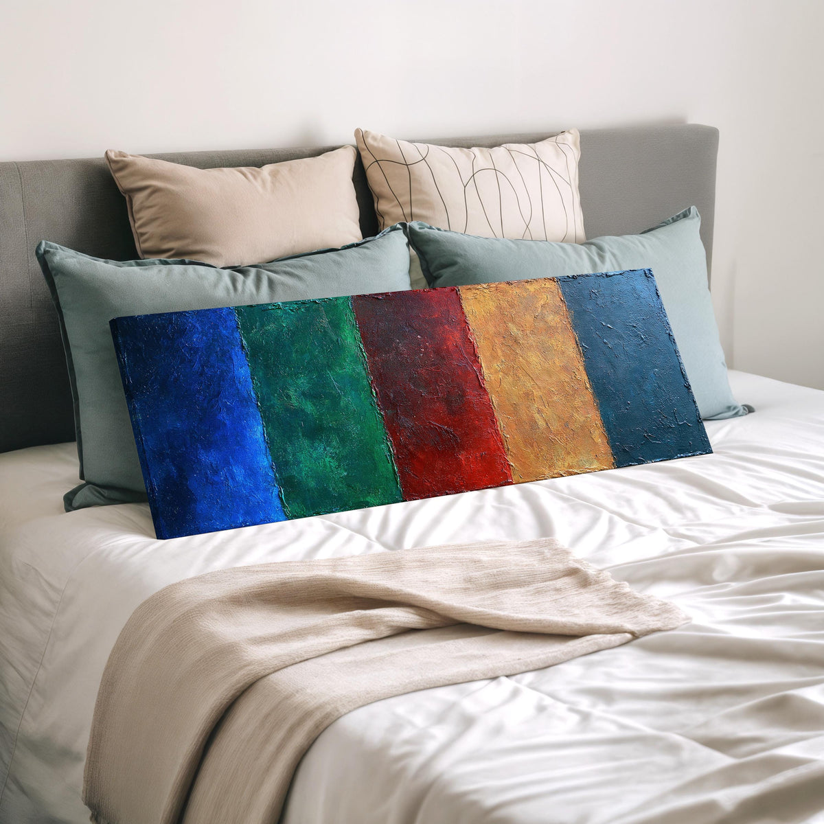 Textured jewel tone vertical bands wide panoramic canvas print laid on a bed to show its size