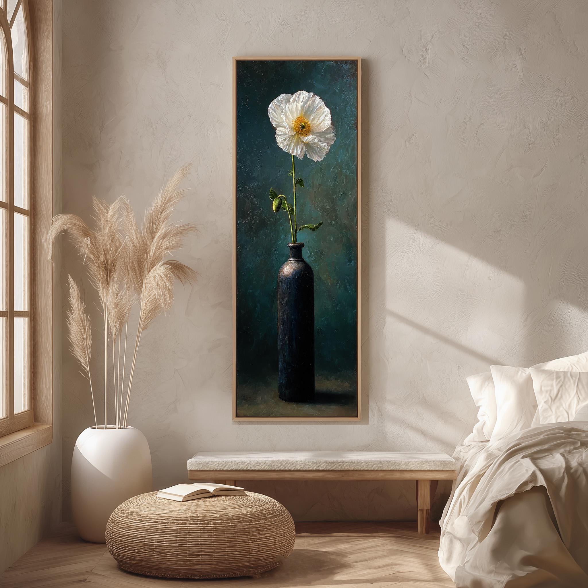 a large painting of a white flower in a blue vase hanging on a wall in a minimalist living room setting.