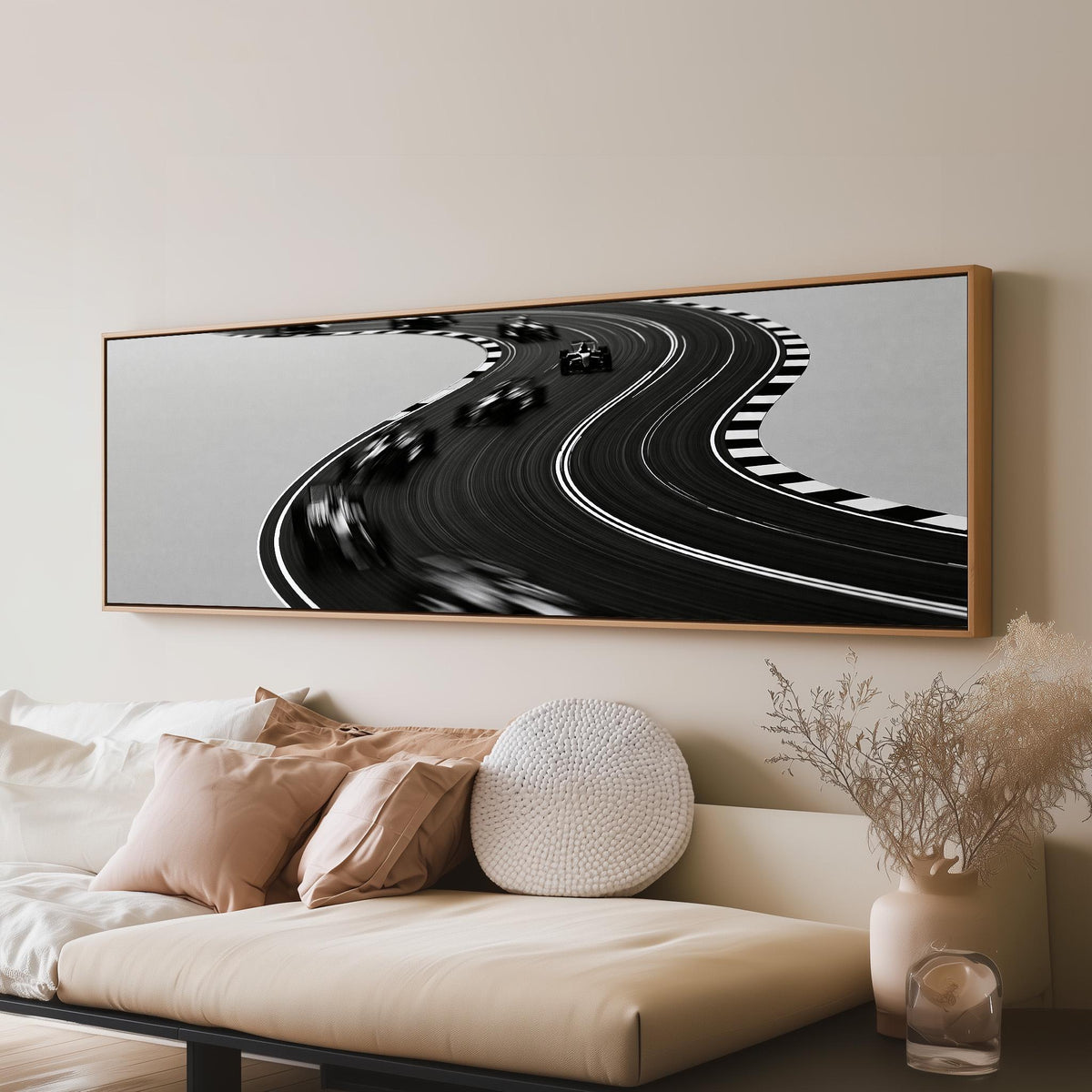 Winding race track in monochrome panoramic canvas print above a sofa in a living room