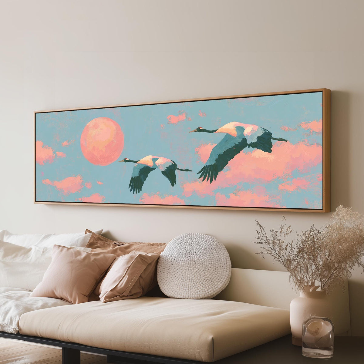 Two cranes flying at sunset long horizontal canvas print above a sofa in a living room