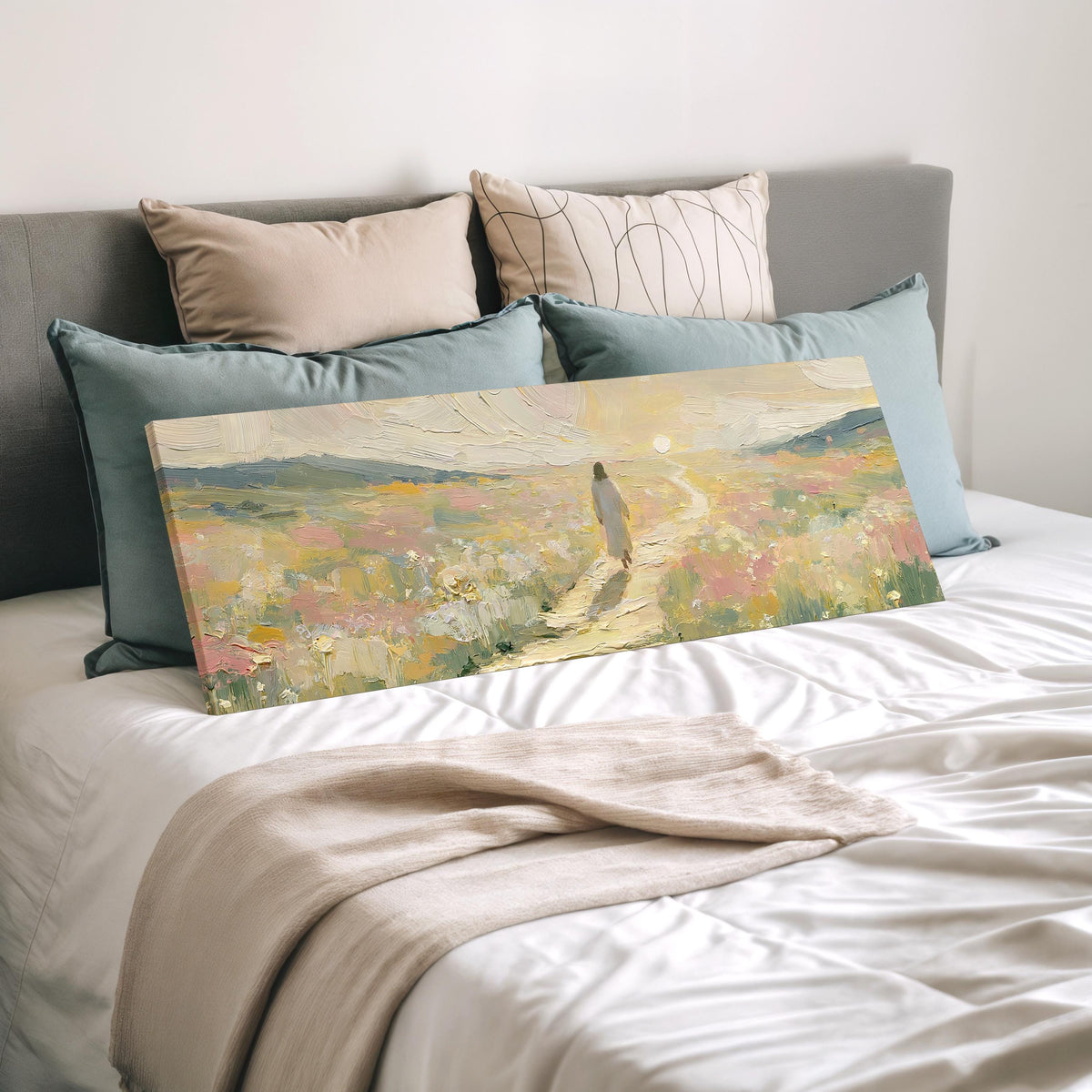 Jesus walking a pastel meadow path wide panoramic canvas print laid on a bed to show its size