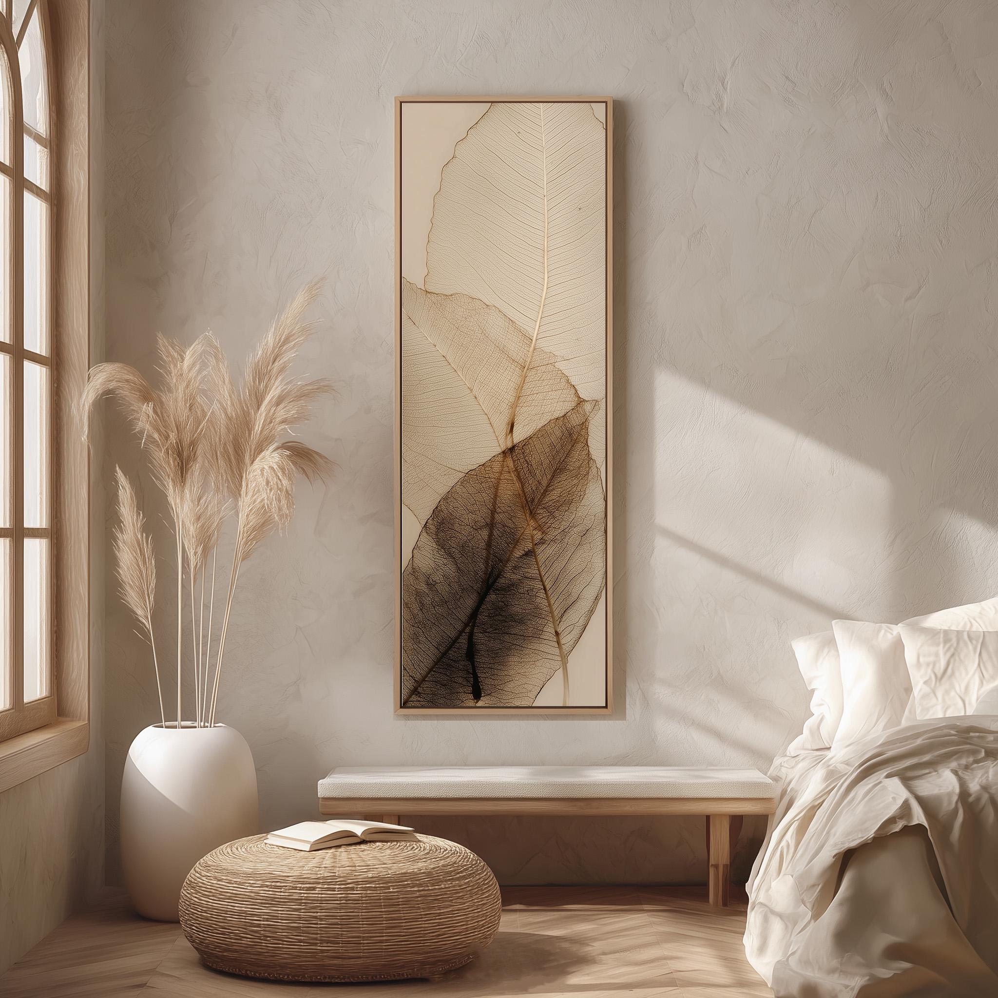 a serene and minimalist bedroom interior, featuring a large framed artwork of leafy textures on the wall, a white bed with a white pillow, a white ottoman, and a potted plant with long, feathery leaves.