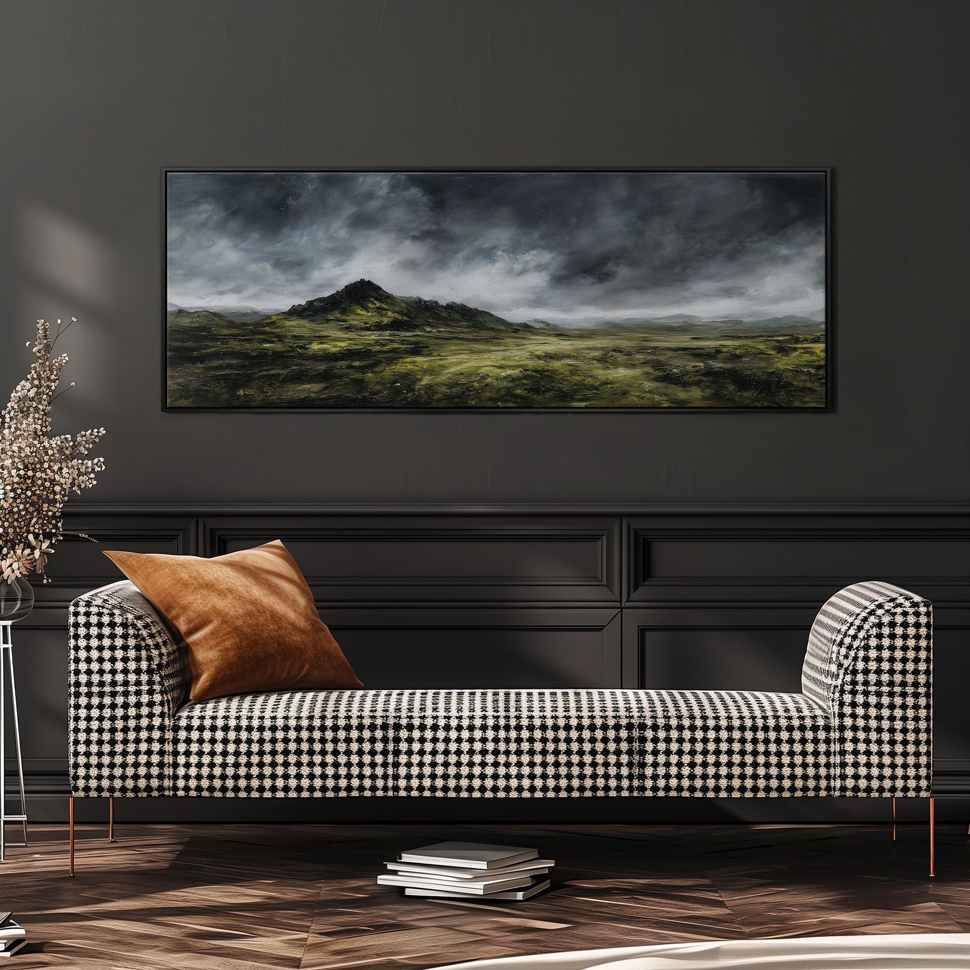 a black and white checkered sofa with a brown throw pillow, set against a dark wall with a large landscape painting hanging above it.