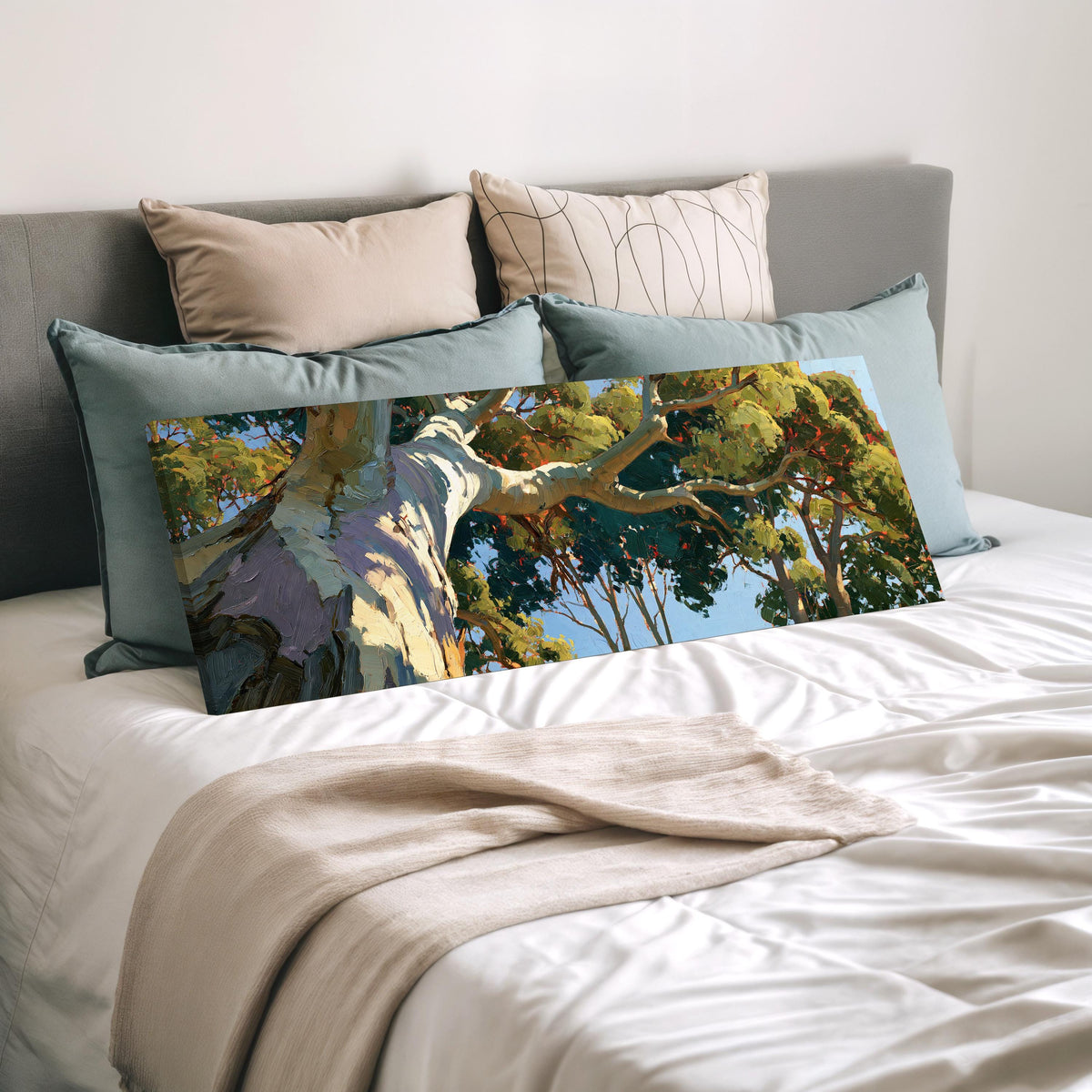 Sunlit eucalyptus trunk and branches wide panoramic canvas print laid on a bed to show its size
