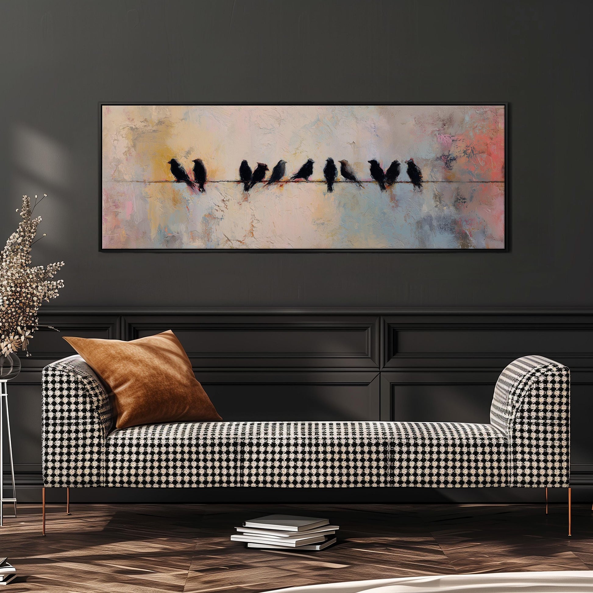 a black and white checkered sofa with a brown throw pillow, set against a dark wall with a large painting of birds perched on a wire above it.
