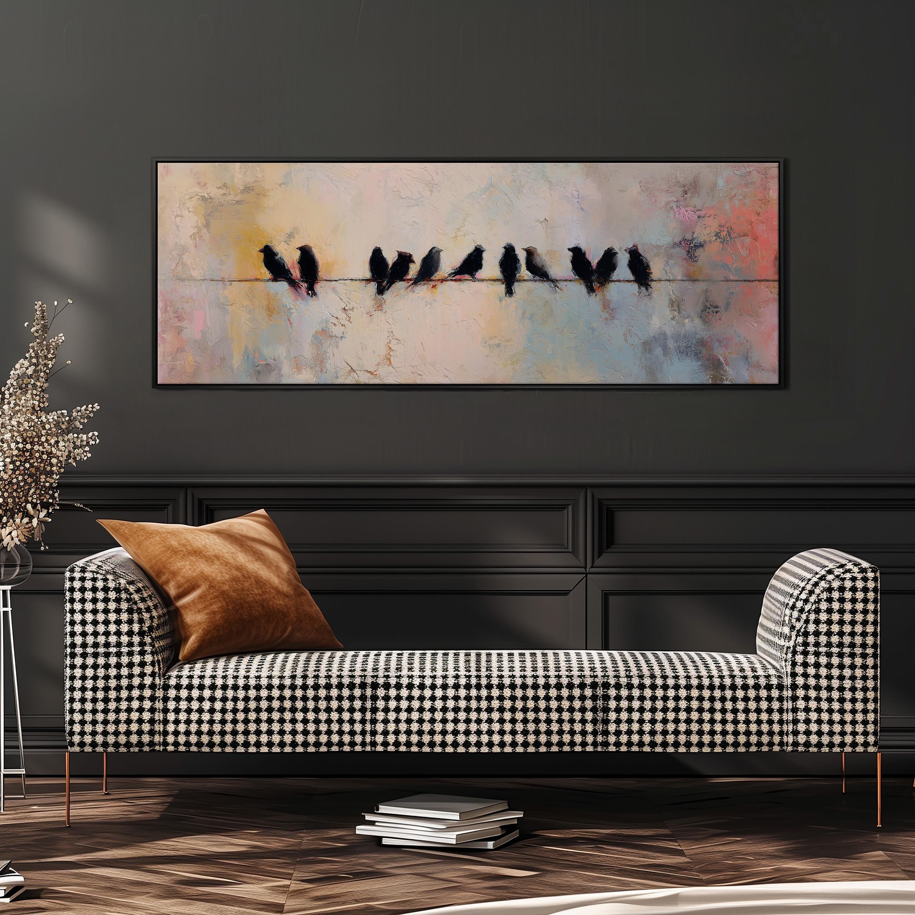 a black and white checkered sofa with a brown throw pillow, set against a dark wall with a large painting of birds perched on a wire above it.