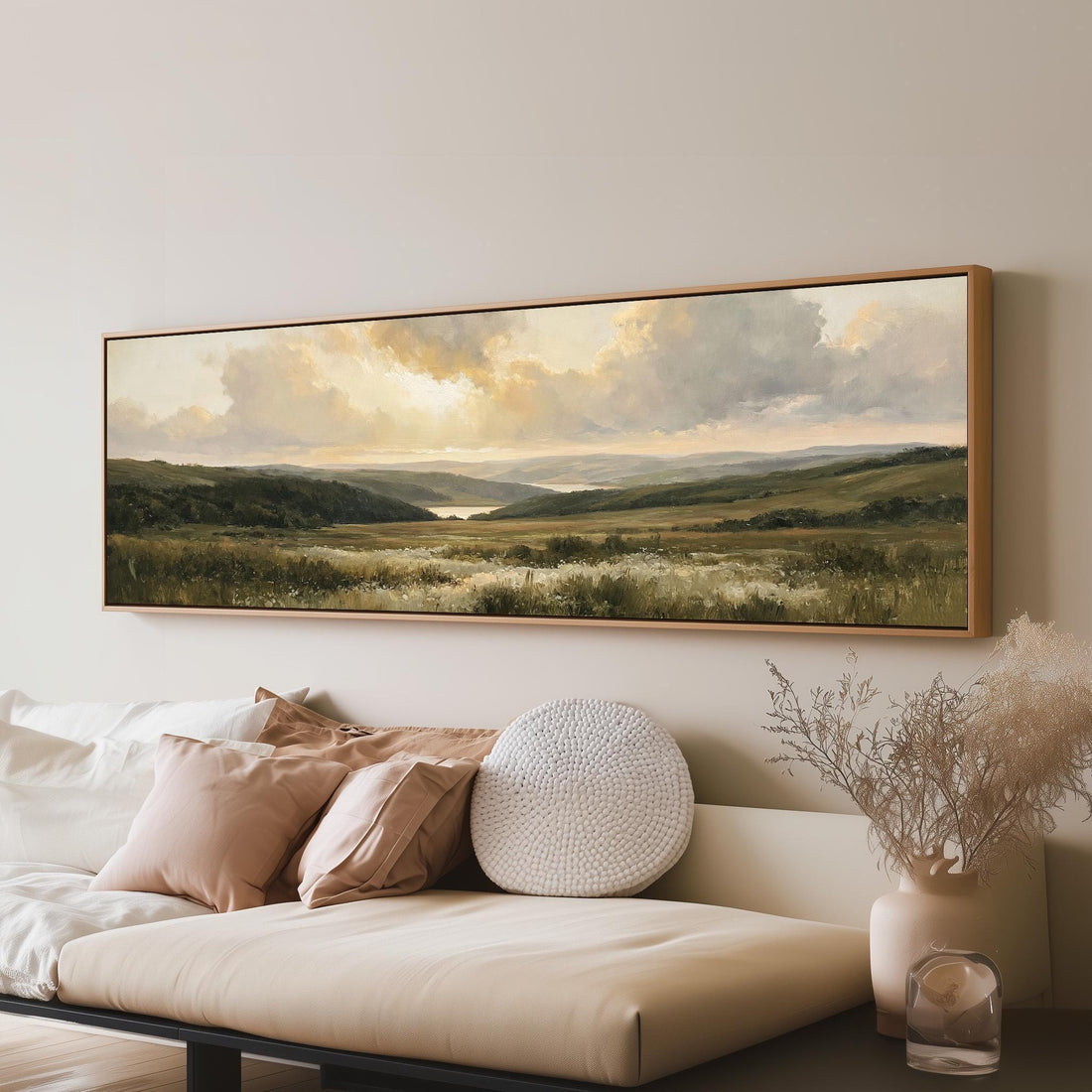 Rolling hills and a lake at golden sunset long horizontal canvas print above a sofa in a living room