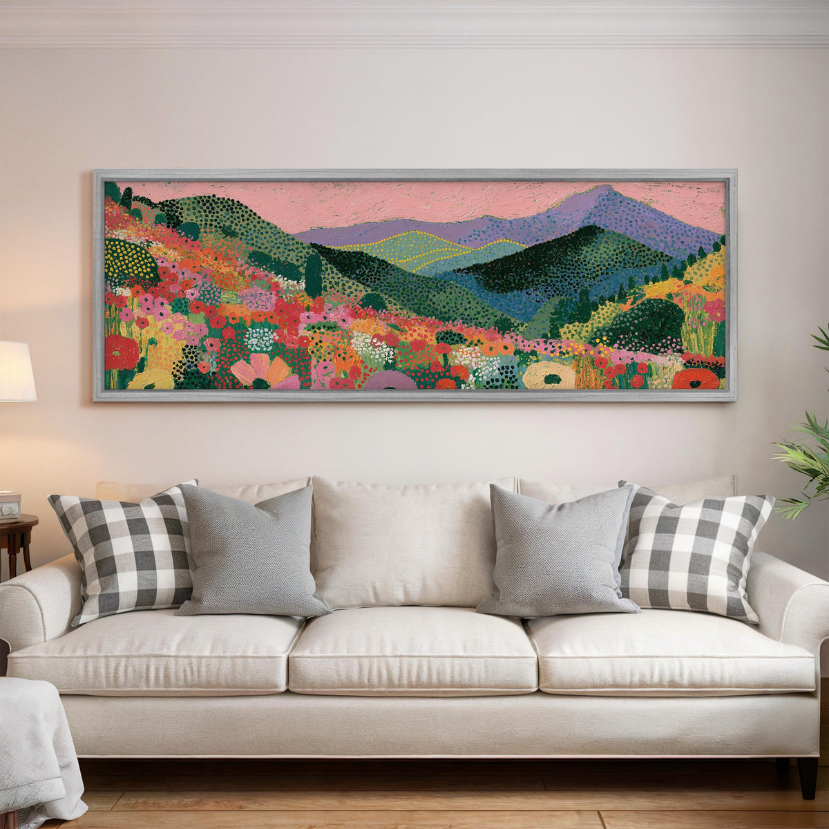Purple mountains over a flower meadow panoramic canvas print above a white sofa in a bright living room