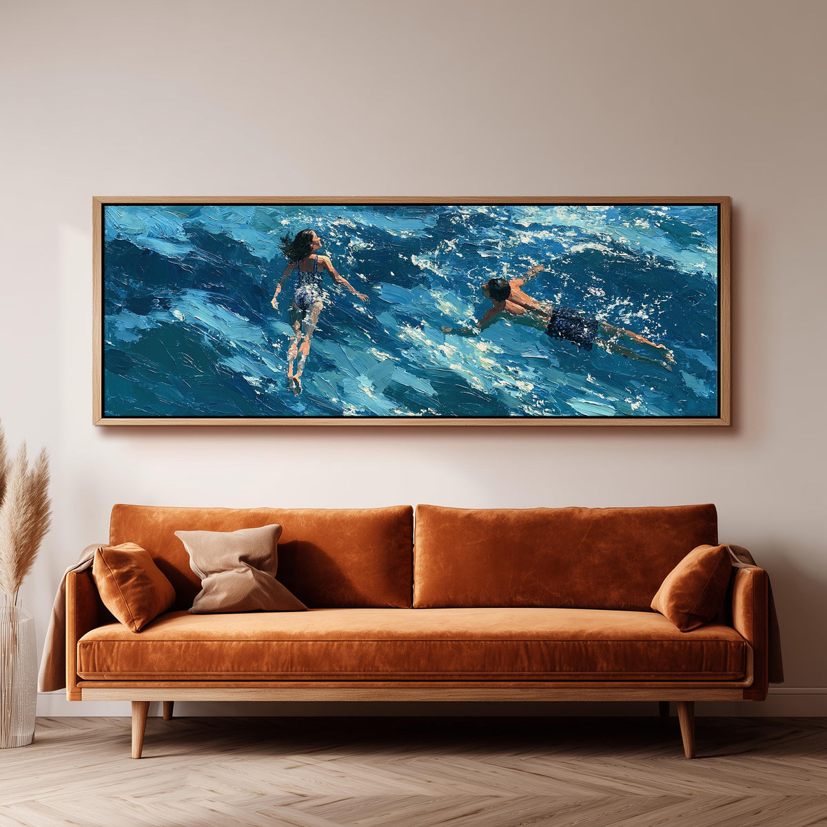 Two swimmers in turquoise waves long horizontal canvas print above a sofa in a living room