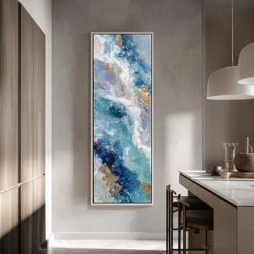 a large, abstract painting hanging on a wall in a modern kitchen. The painting depicts a swirling pattern of blue, white, and gold colors, creating a sense of movement and energy. The kitchen itself has a clean, minimalist design with white cabinets and a marble countertop.