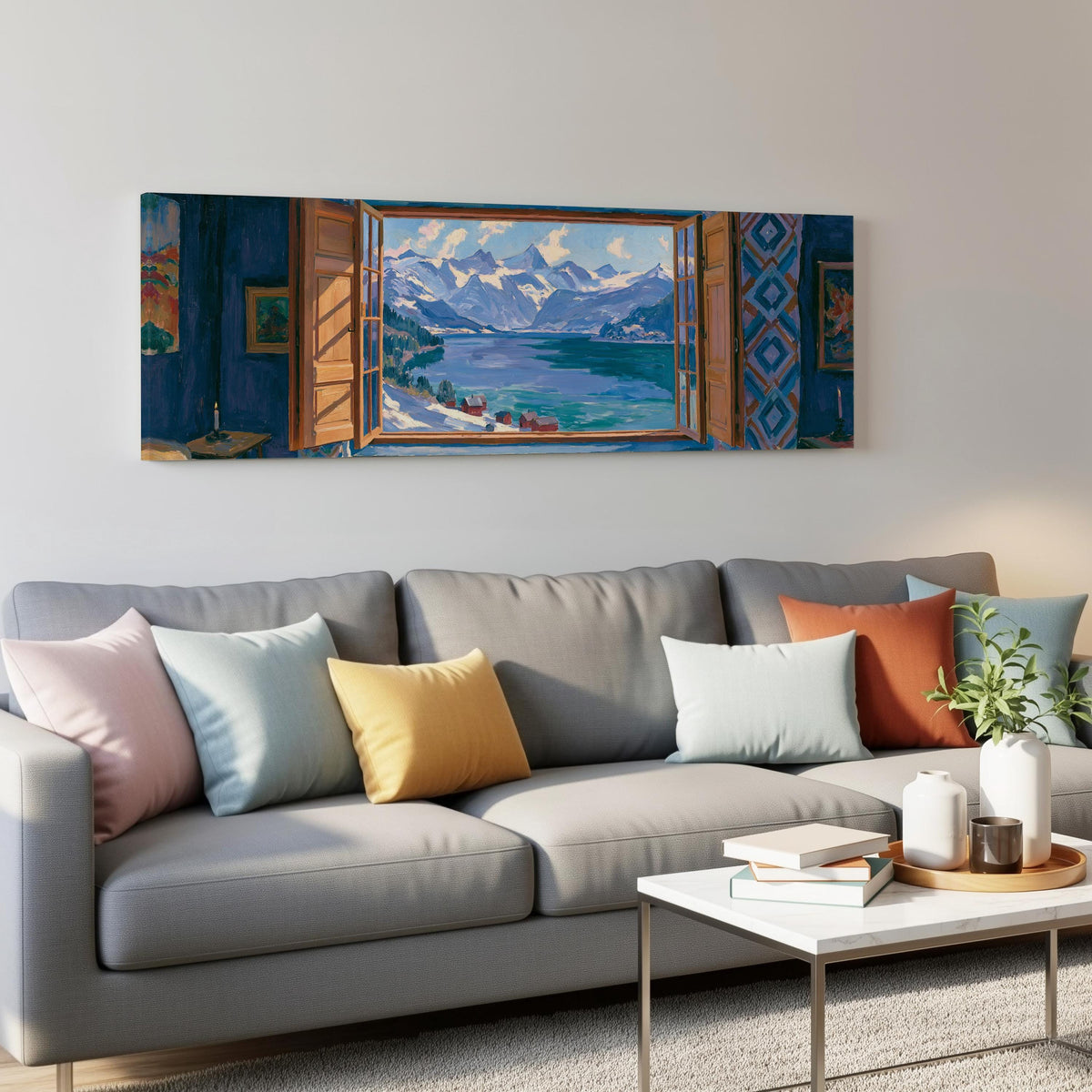 Snowy alpine lake seen through a window panoramic canvas print above a grey sofa in a living room