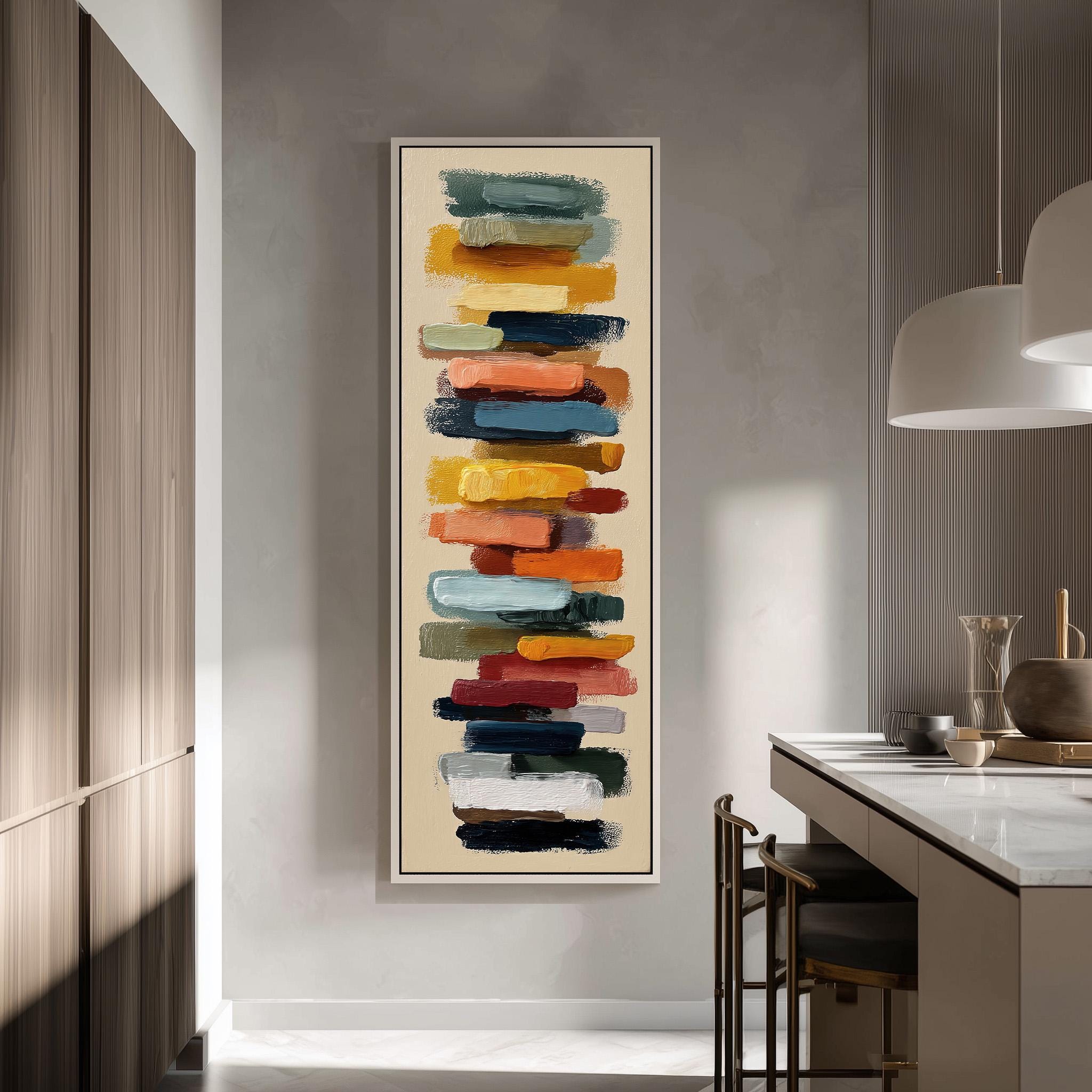 a modern kitchen with a large abstract painting hanging on the wall. The painting consists of a vertical arrangement of colorful brushstrokes in various shades of orange, yellow, green, blue, and red. The kitchen is equipped with a white countertop, a sink, and a dining table with chairs. The overall design and color scheme create a vibrant and lively atmosphere in the space.