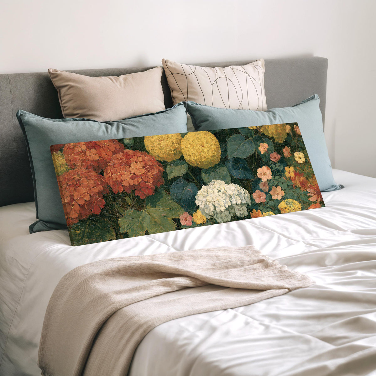 Warm hydrangea and dahlia bouquet wide panoramic canvas print laid on a bed to show its size