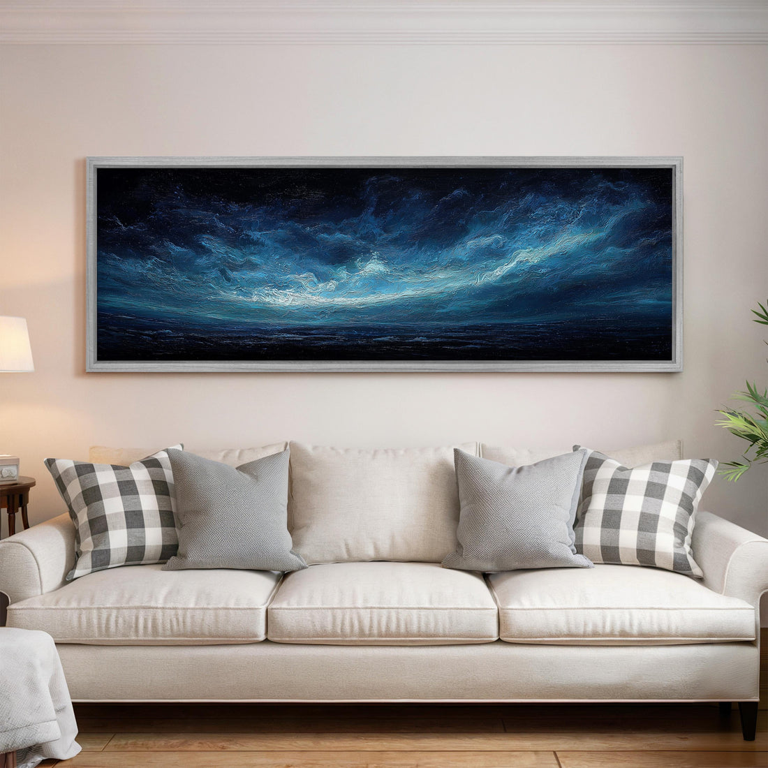a black and white checkered sofa with a brown throw pillow, positioned in front of a large black and white wall art depicting a night sky with clouds.