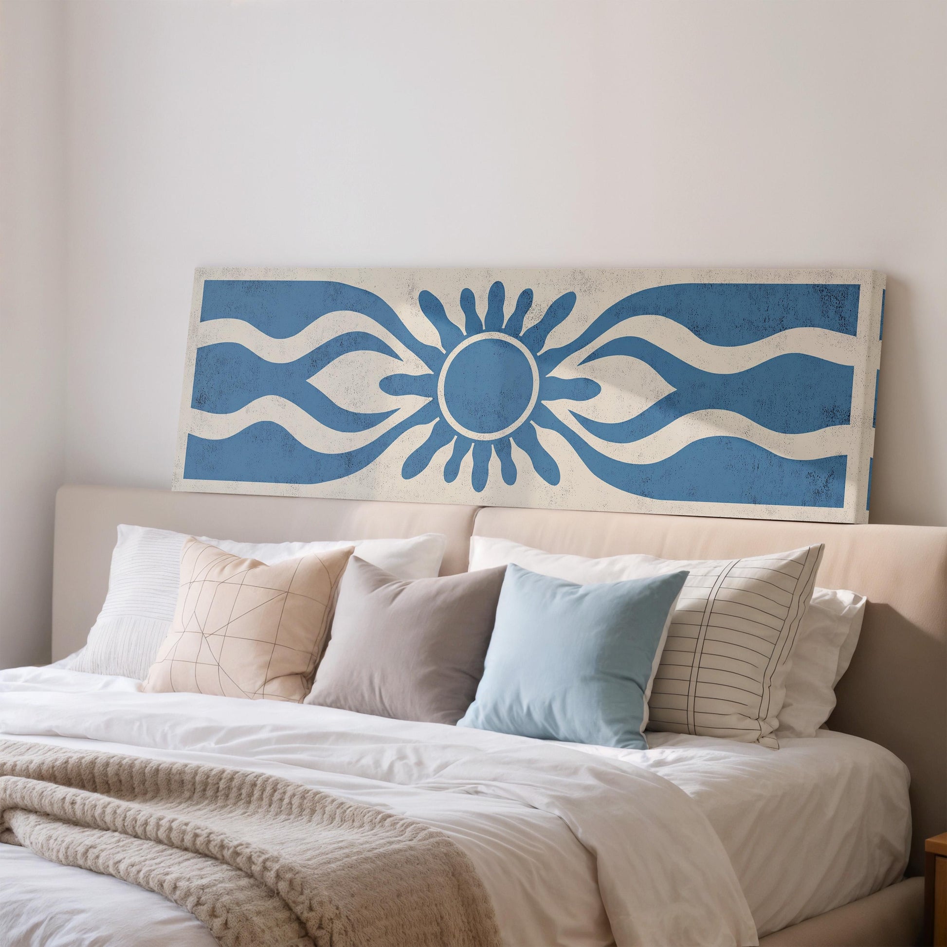 a neatly made bed with a blue and white patterned headboard above it.