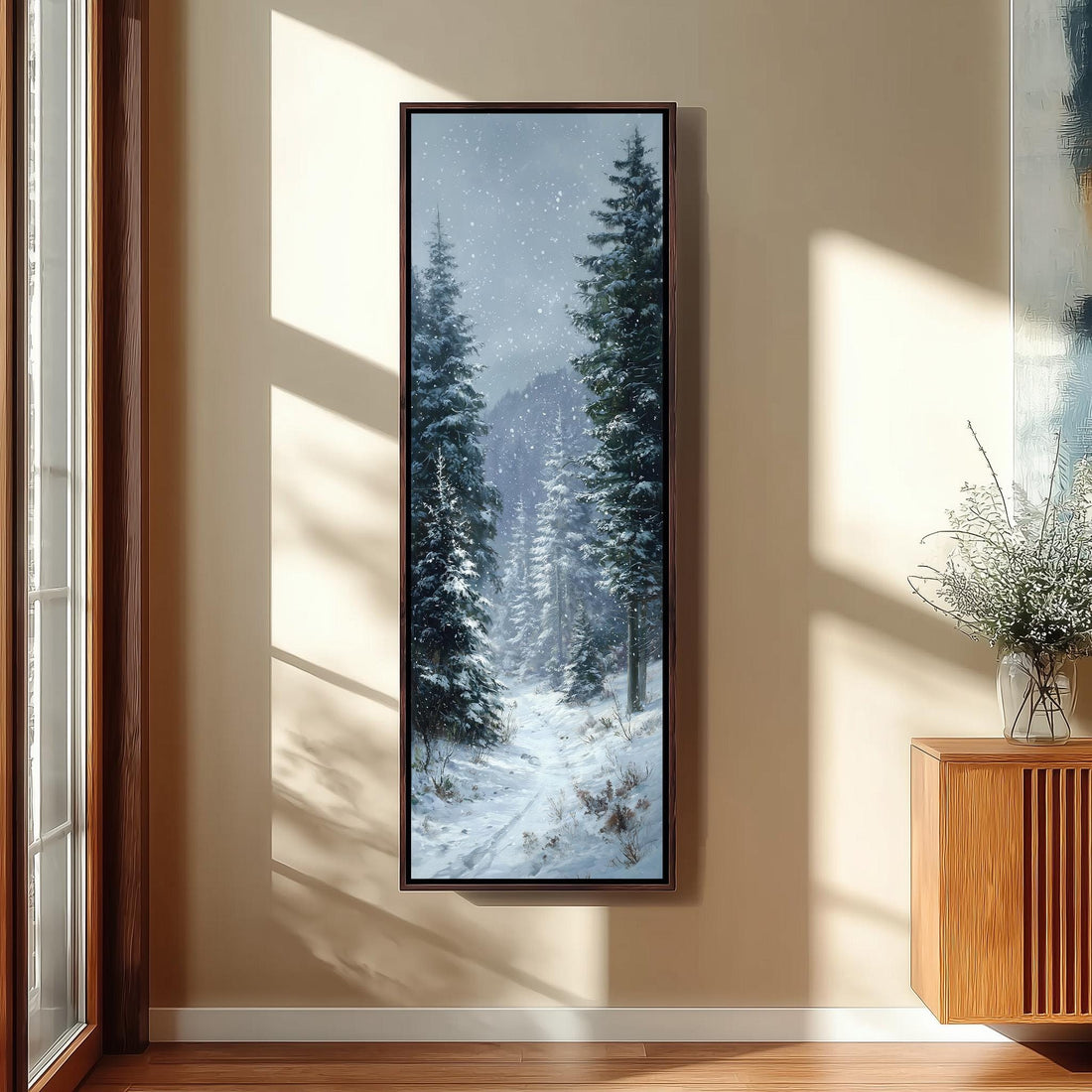 a large, framed painting of a snowy forest scene hanging on a wall in a modern, minimalist kitchen.