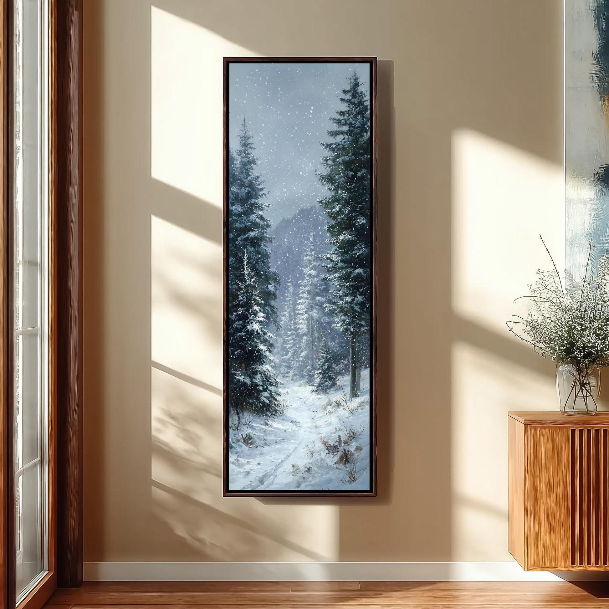 a large, framed painting of a snowy forest scene hanging on a wall.