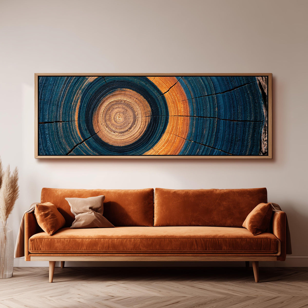 Teal and orange tree ring panoramic canvas print above a sofa in a living room