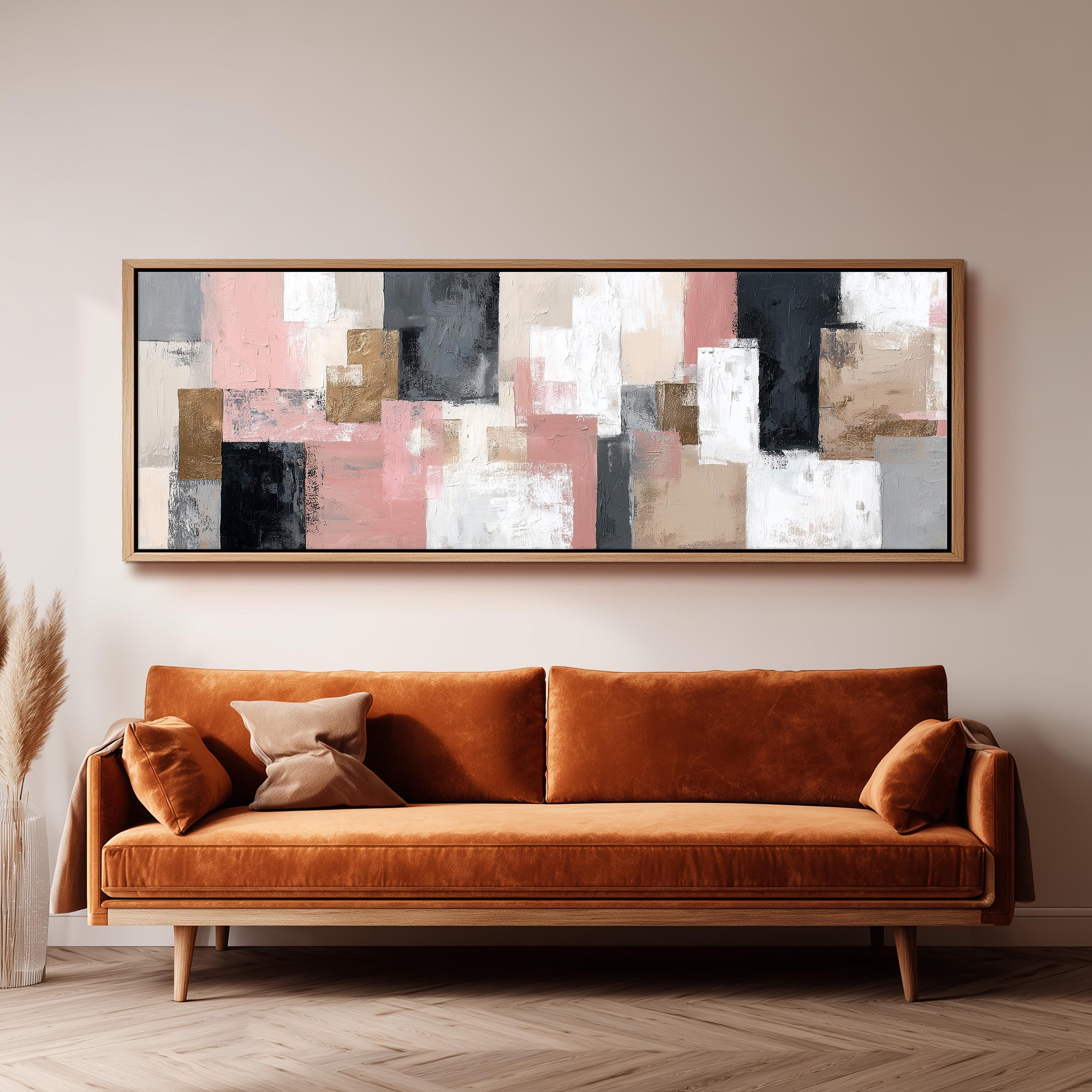 a large abstract painting hanging on a wall above a brown sofa with two pillows.
