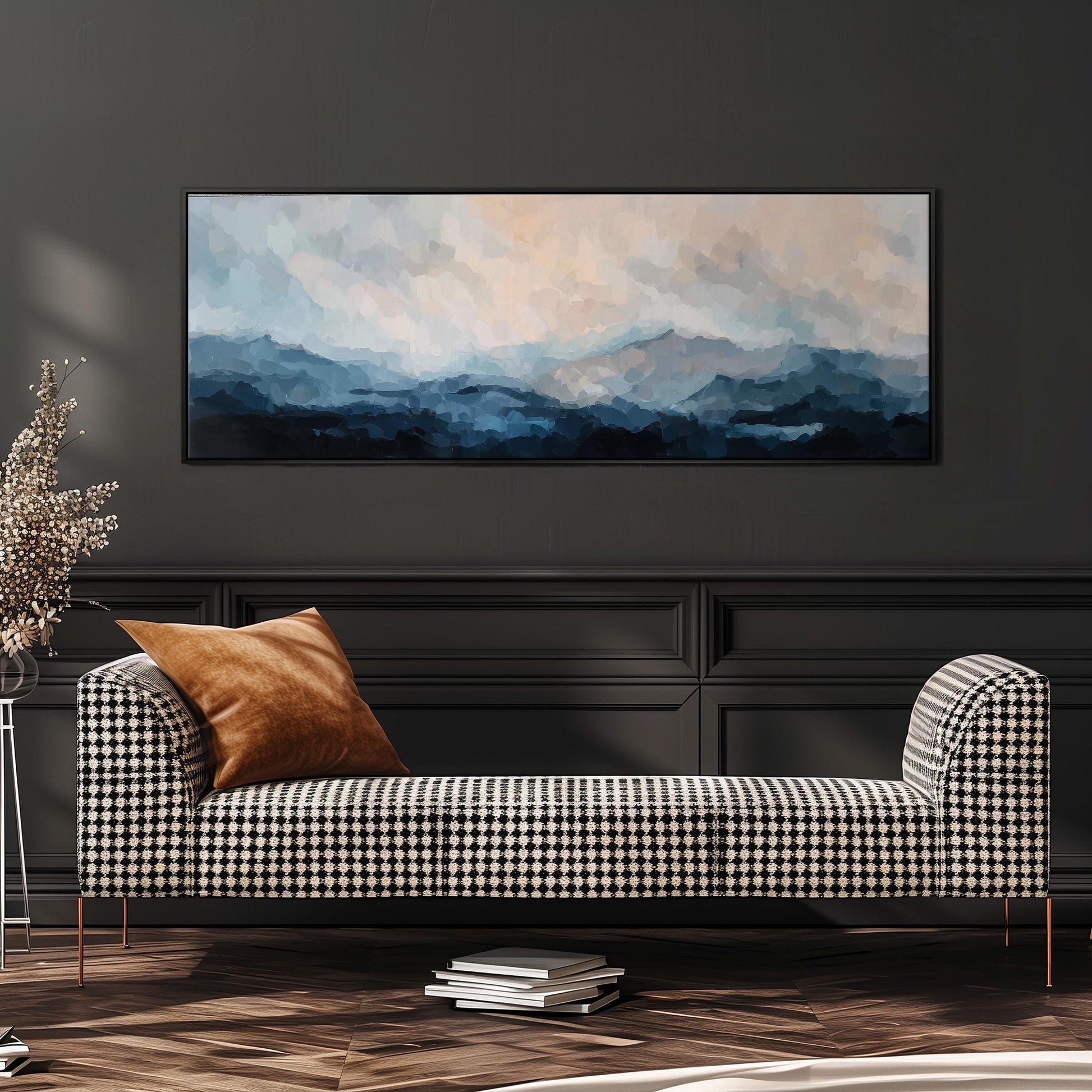 a black and white checkered sofa with a brown throw pillow, positioned in front of a large painting depicting a mountainous landscape.