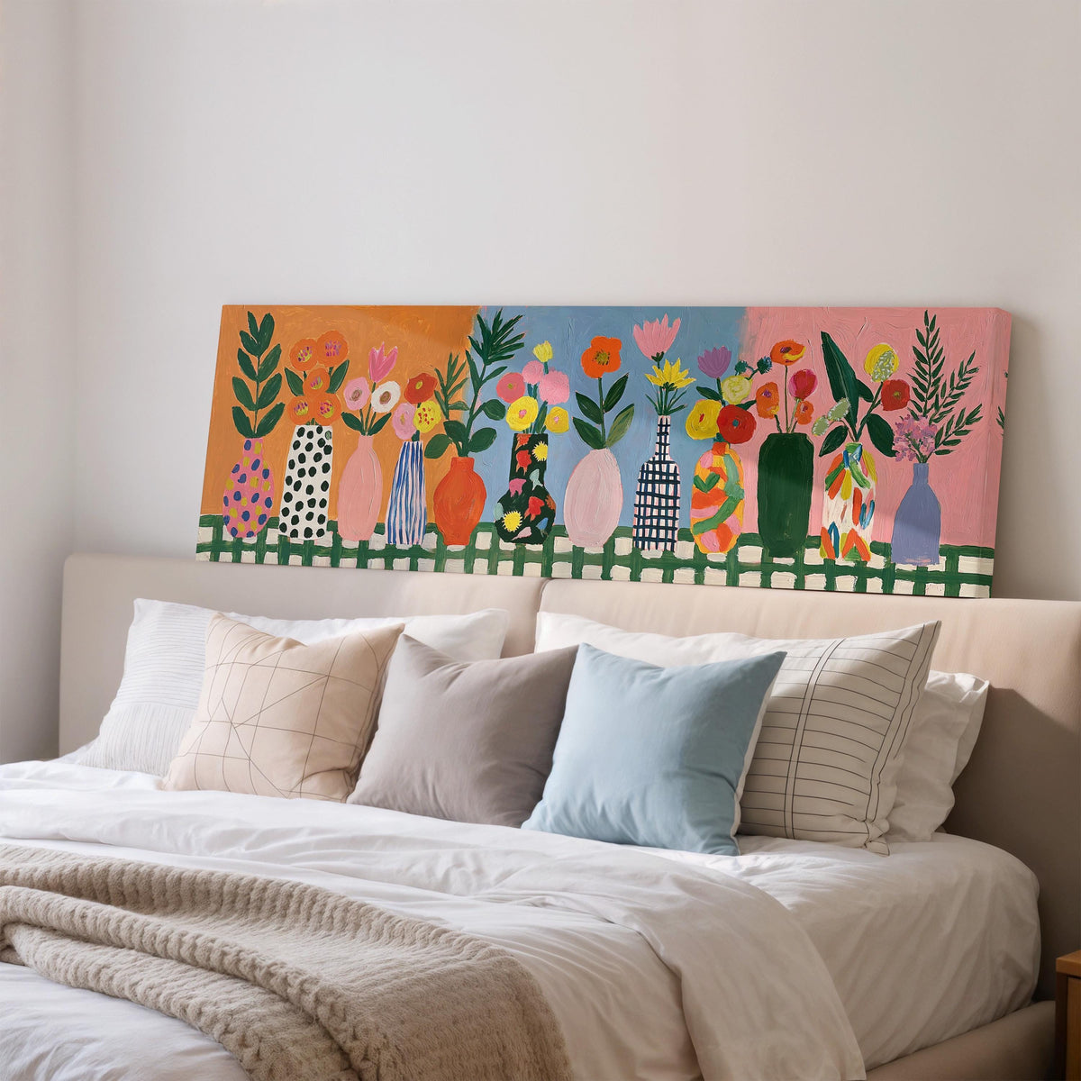 Folk art flower vases on orange and blue wide panoramic canvas print above a bed in a bedroom