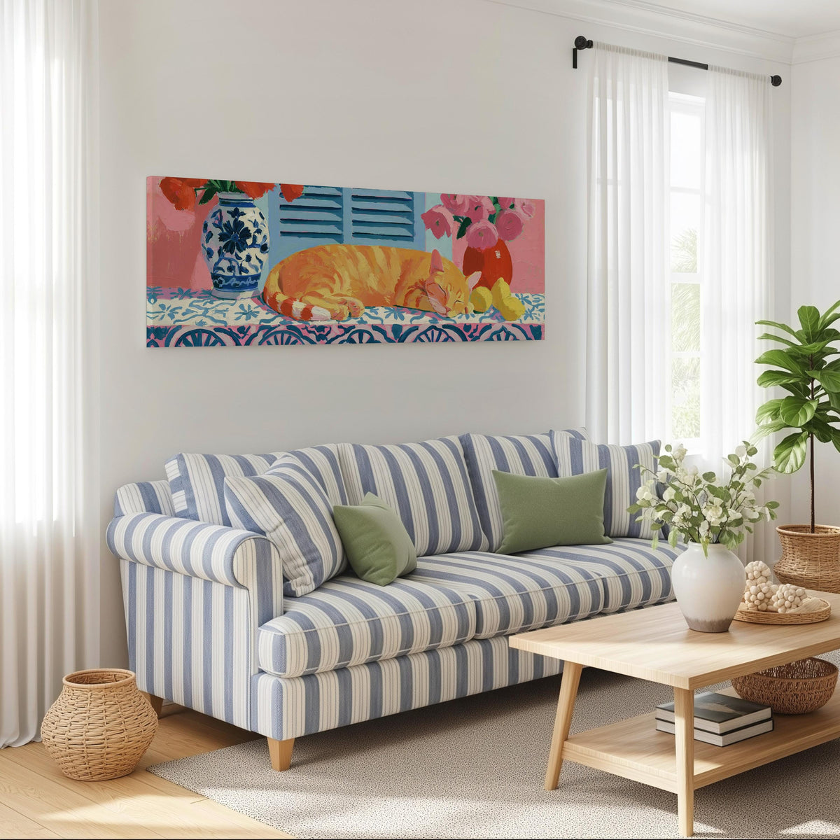 Orange cat napping on a tiled table long horizontal canvas print above a striped sofa in a coastal living room