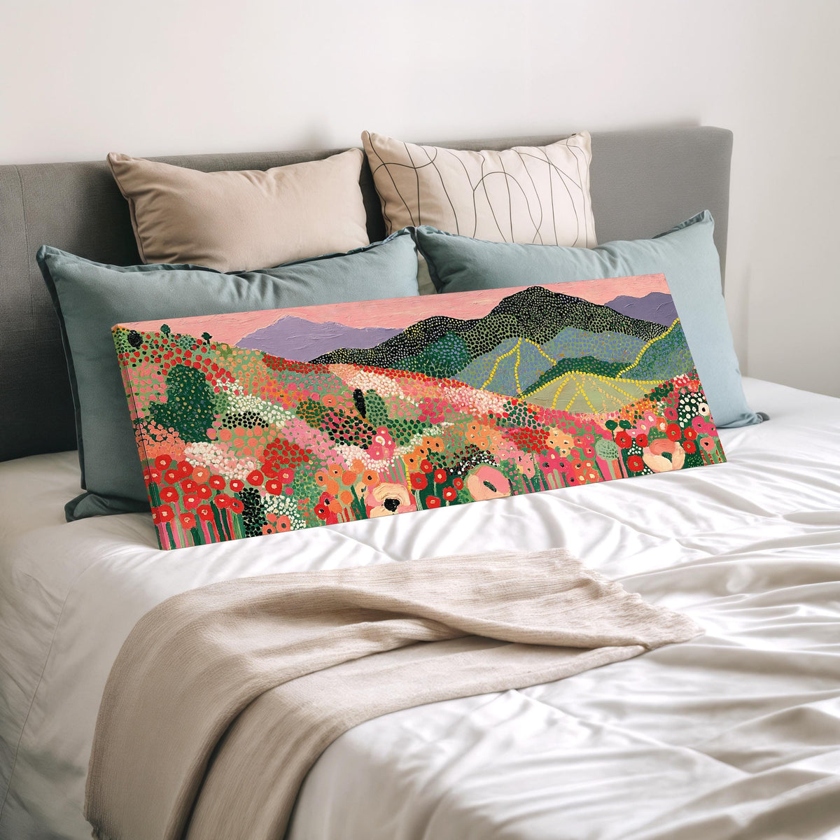 Dotted poppy mountains under a pink sky wide panoramic canvas print laid on a bed to show its size