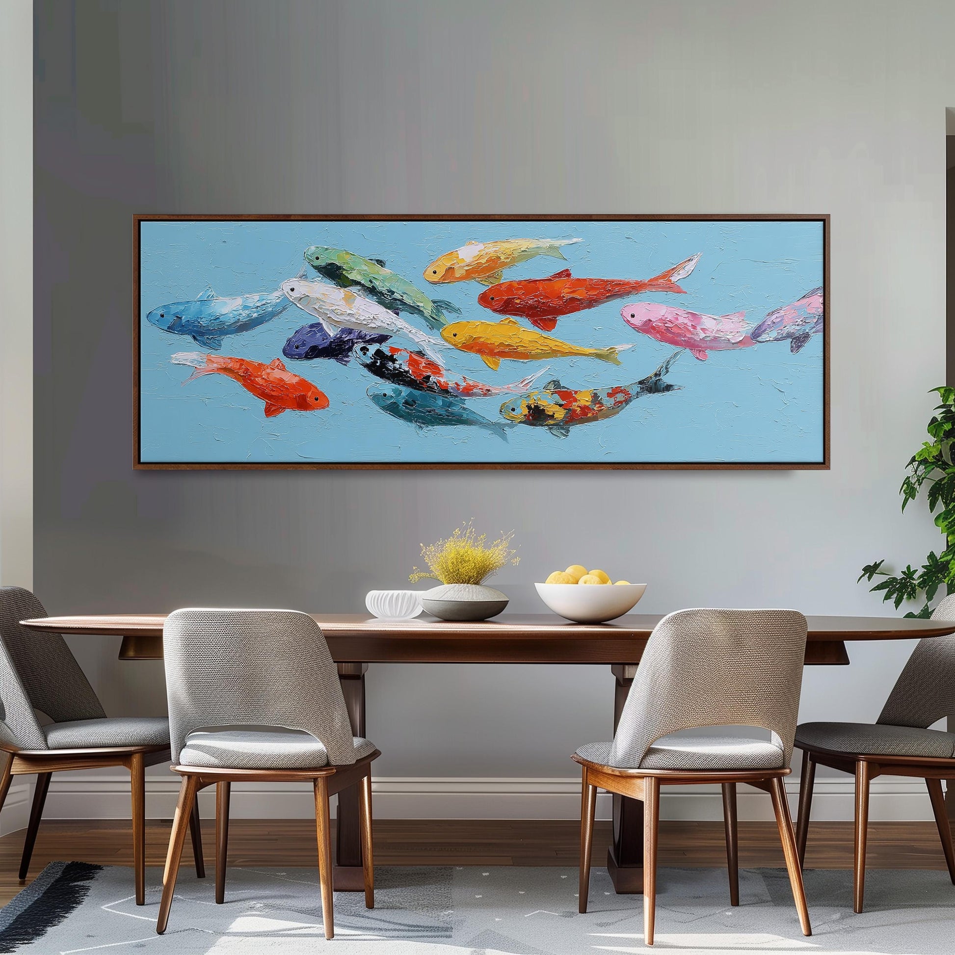 a large painting of colorful fish swimming in the ocean, hanging on a wall above a wooden dining table with four chairs.