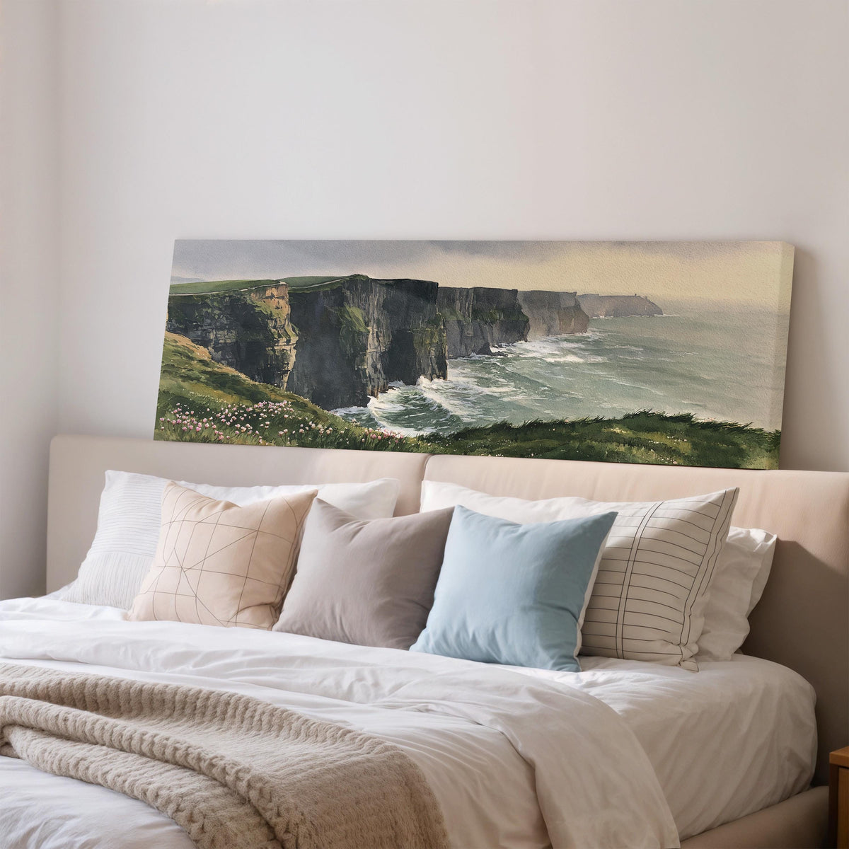Green sea cliffs with wildflowers wide panoramic canvas print above a bed in a bedroom