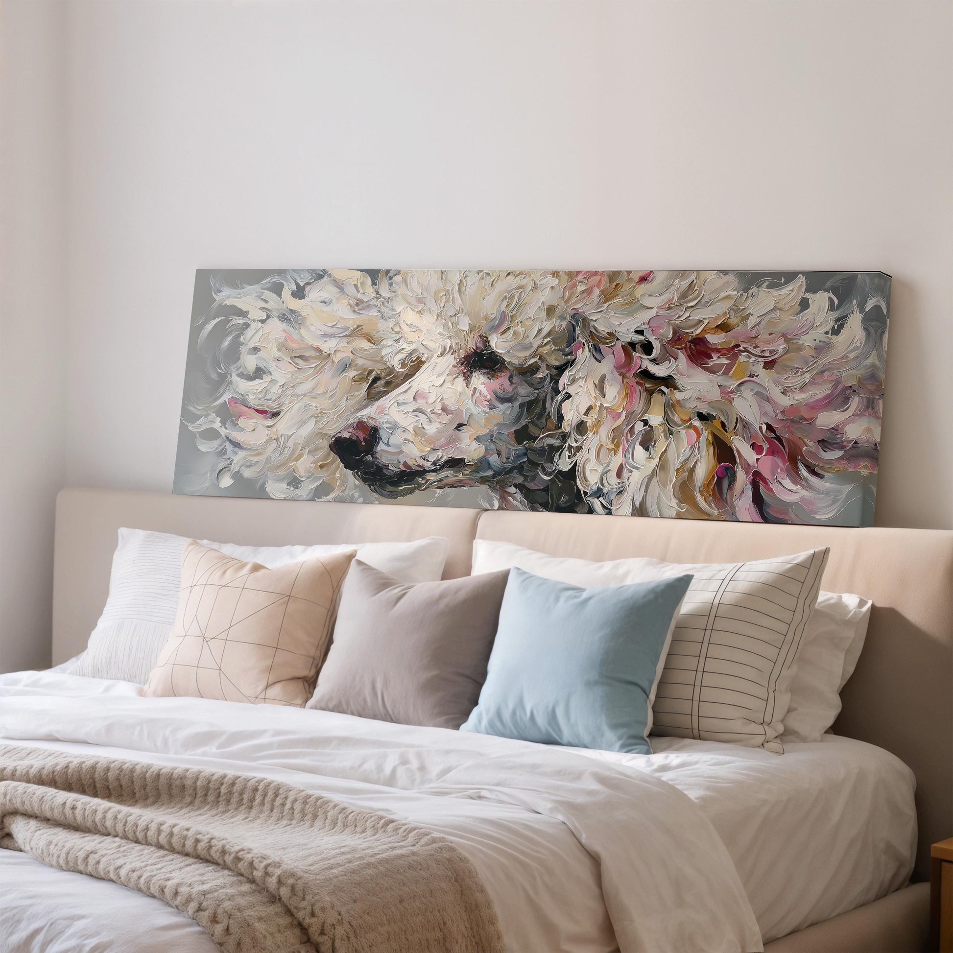 a large painting of a poodle's head on a wall above a bed with white bedding and various pillows.