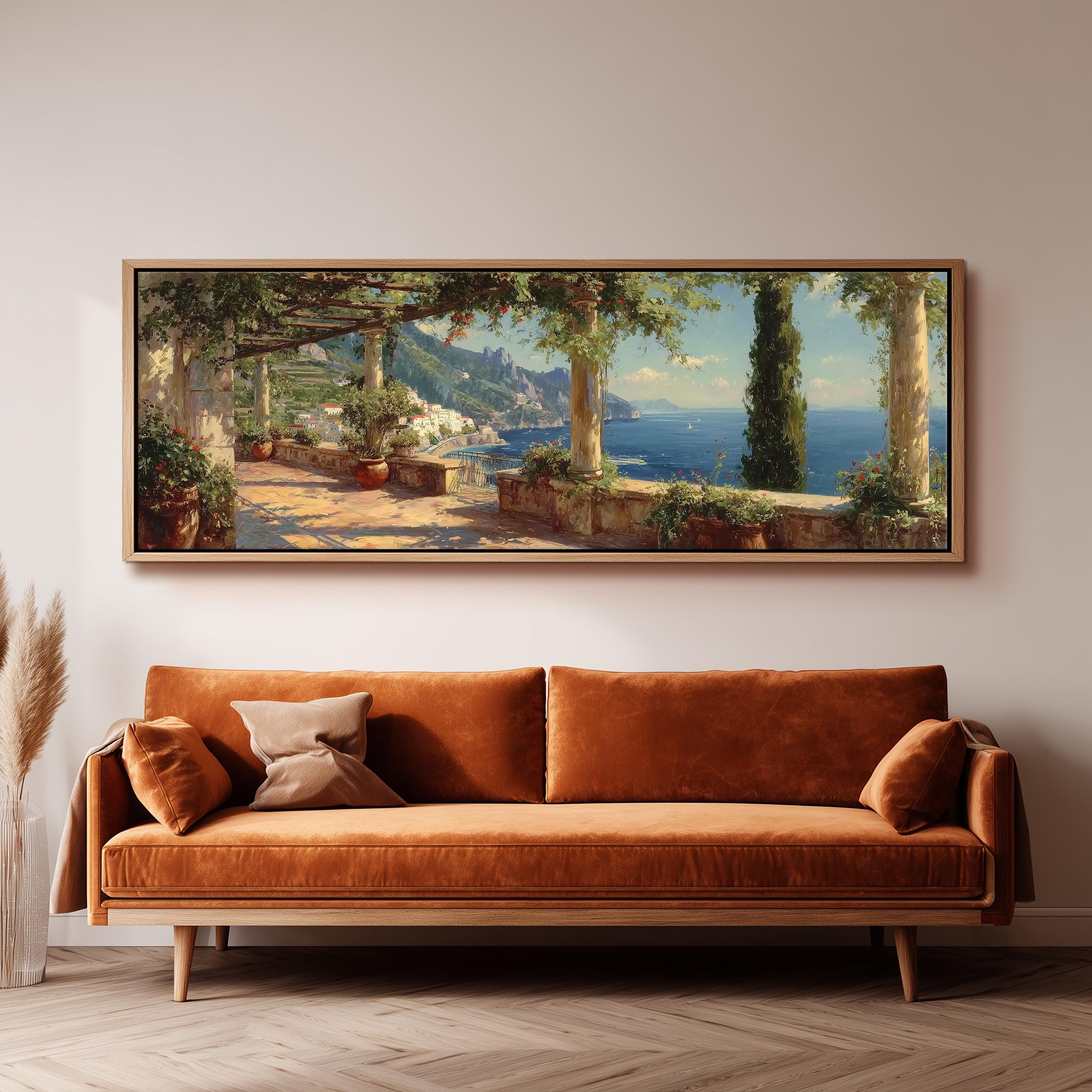 a large, framed painting of a scenic coastal landscape hanging on a wall above a brown sofa.