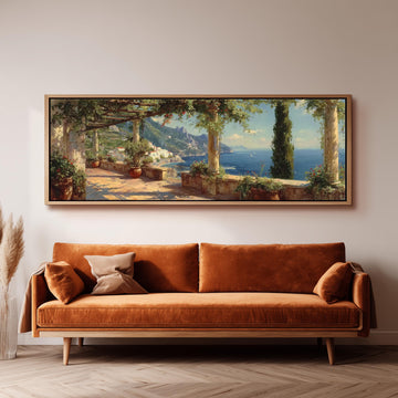 a large, framed painting of a scenic coastal landscape hanging on a wall above a brown sofa.