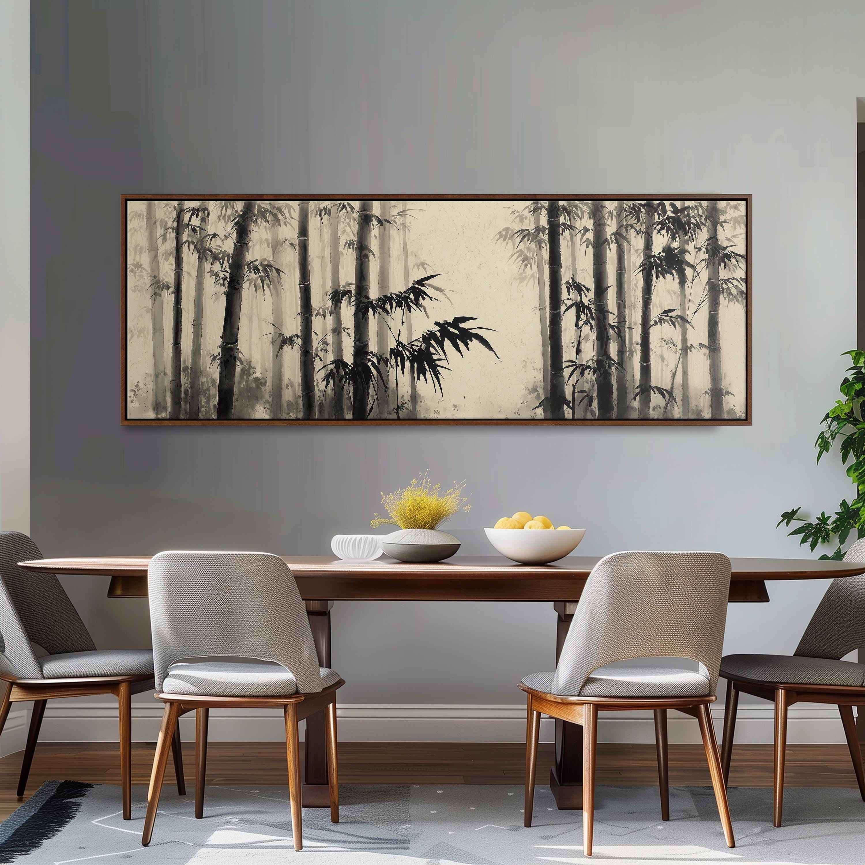 a dining room with a large black and white painting of bamboo trees hanging on the wall above a wooden dining table with four chairs. The table is set with a bowl of fruit and a vase of flowers, creating a cozy and inviting atmosphere.