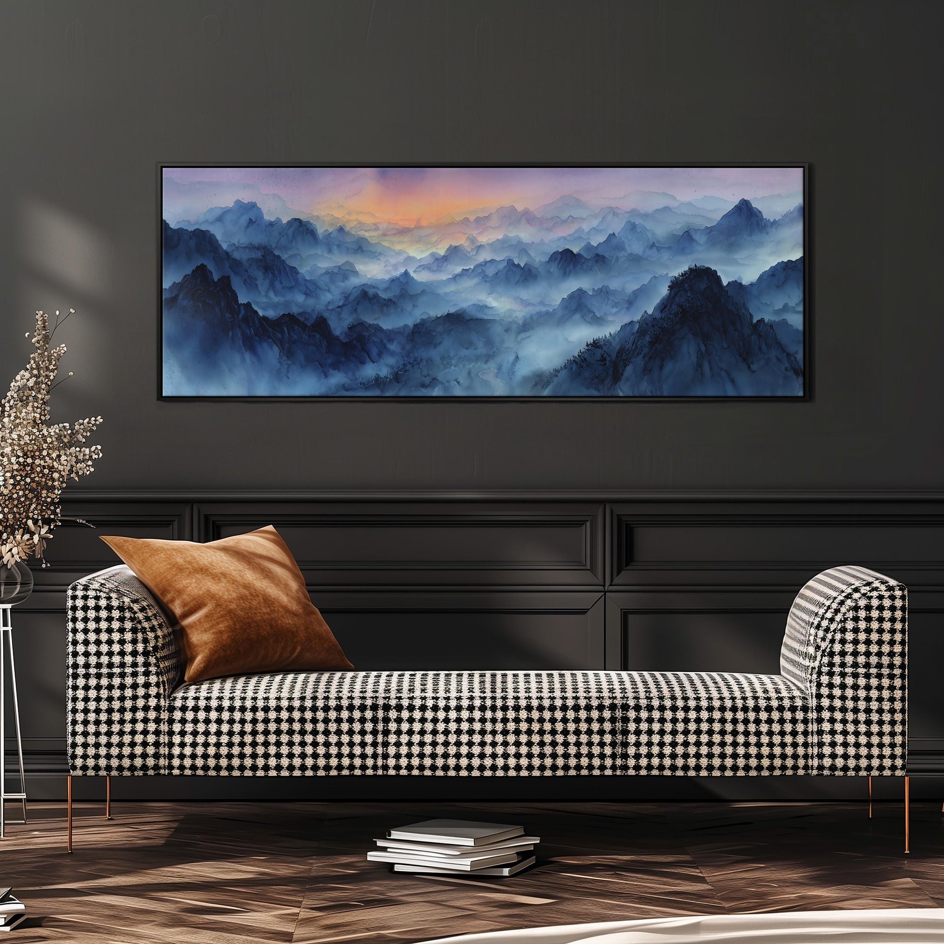 a large, framed landscape painting hanging on a wall above a black and white checkered sofa in a living room setting.