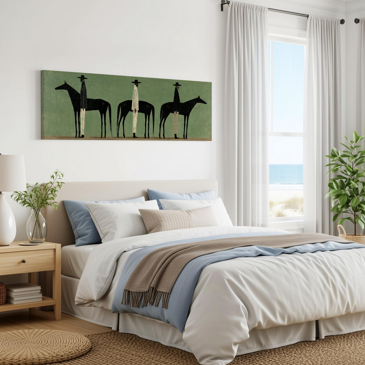 Three stylized cowboys with horses on sage green panoramic canvas print above a bed in a coastal bedroom