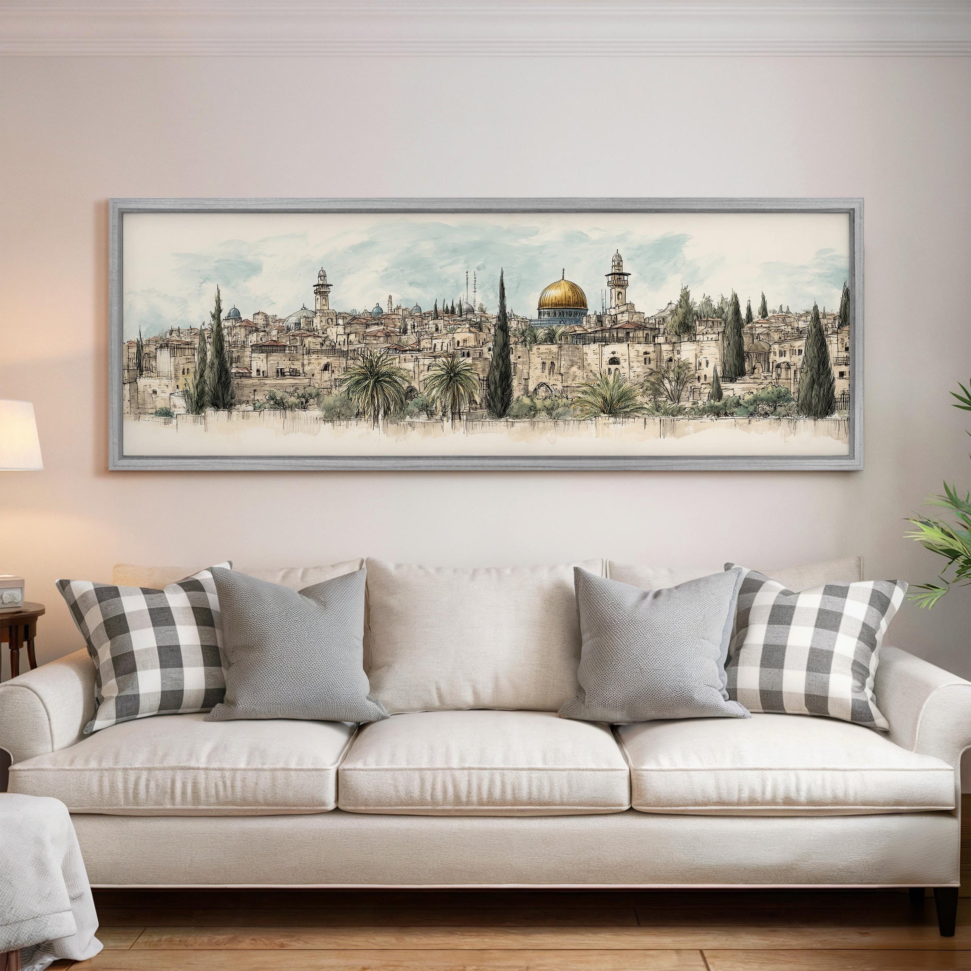 a large framed painting of a cityscape with a prominent dome in the center, hanging on a wall above a white sofa with patterned throw pillows.