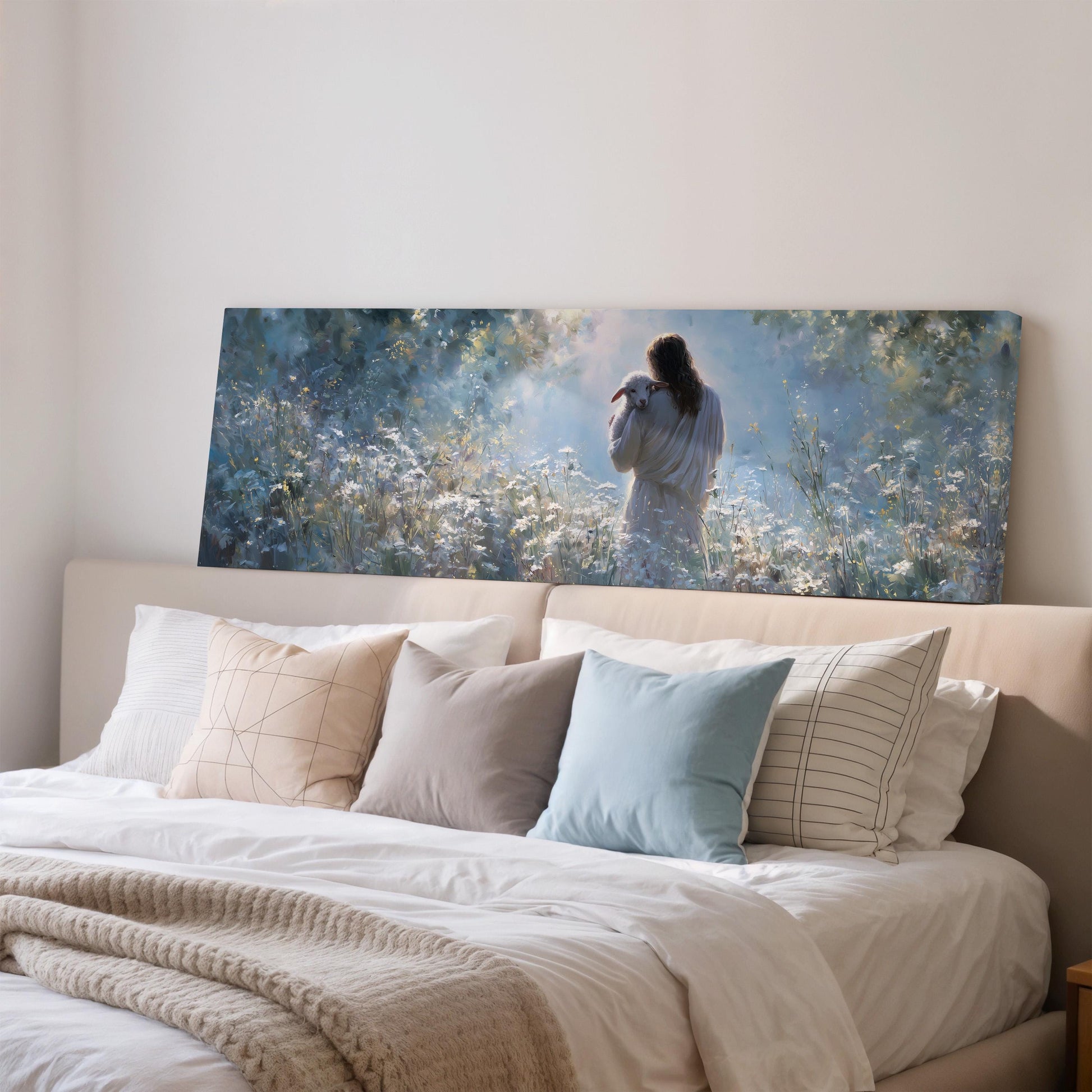 a large painting of a woman standing in a field of flowers, hanging above a bed with white bedding and pillows.